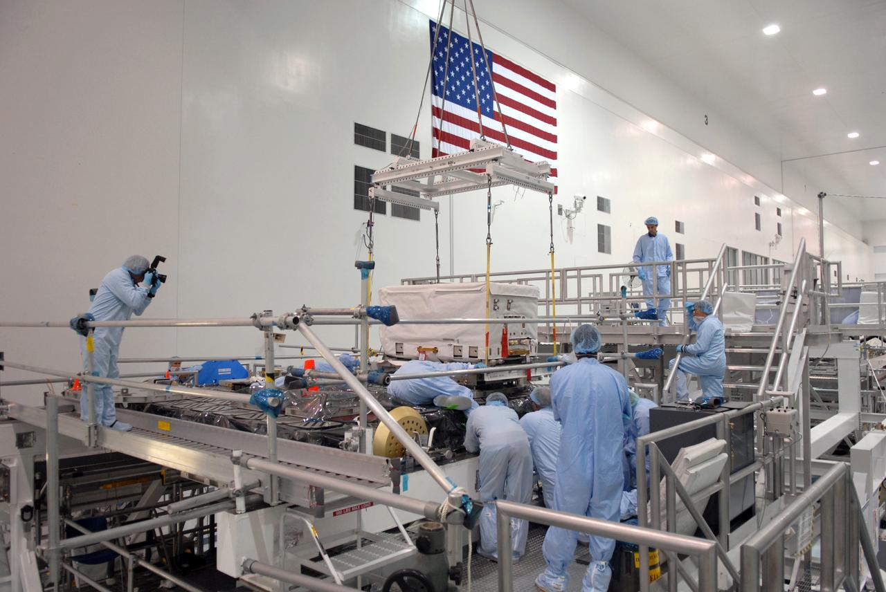 CAPE CANAVERAL, Fla. – In the Space Station Processing Facility at NASA's Kennedy Space Center in Florida, technicians check the placement of the nitrogen tank assembly on the Express Logistics Carrier 1, or ELC-1. The carrier is part of the STS-129 payload on space shuttle Atlantis, which will deliver to the International Space Station two spare gyroscopes, two nitrogen tank assemblies, two pump modules, an ammonia tank assembly and a spare latching end effector for the station's robotic arm. STS-129 is targeted to launch Nov. 12. Photo credit: NASA/Jim Grossmann