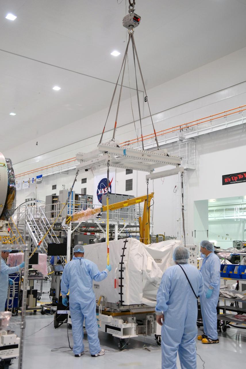 CAPE CANAVERAL, Fla. – In the space Station Processing Facility at NASA's Kennedy Space Center in Florida, technicians prepare to attach the overhead crane to the pump module orbital replacement unit.  The crane will lift and move the equipment to the Express Logistics Carrier 1, or ELC-1. The carrier is part of the STS-129 payload on space shuttle Atlantis, which will deliver to the International Space Station two spare gyroscopes, two nitrogen tank assemblies, two pump modules, an ammonia tank assembly and a spare latching end effector for the station's robotic arm. STS-129 is targeted to launch Nov. 12. Photo credit: NASA/Jim Grossmann