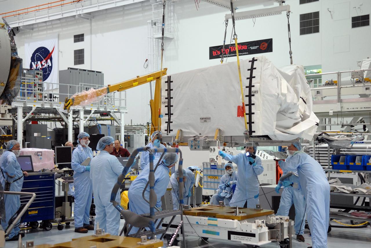 CAPE CANAVERAL, Fla. – In the space Station Processing Facility at NASA's Kennedy Space Center in Florida, technicians watch closely as the overhead crane lifts the pump module orbital replacement unit. The module will be moved to the Express Logistics Carrier 1, or ELC-1, for installation. The carrier is part of the STS-129 payload on space shuttle Atlantis, which will deliver to the International Space Station two spare gyroscopes, two nitrogen tank assemblies, two pump modules, an ammonia tank assembly and a spare latching end effector for the station's robotic arm. STS-129 is targeted to launch Nov. 12. Photo credit: NASA/Jim Grossmann