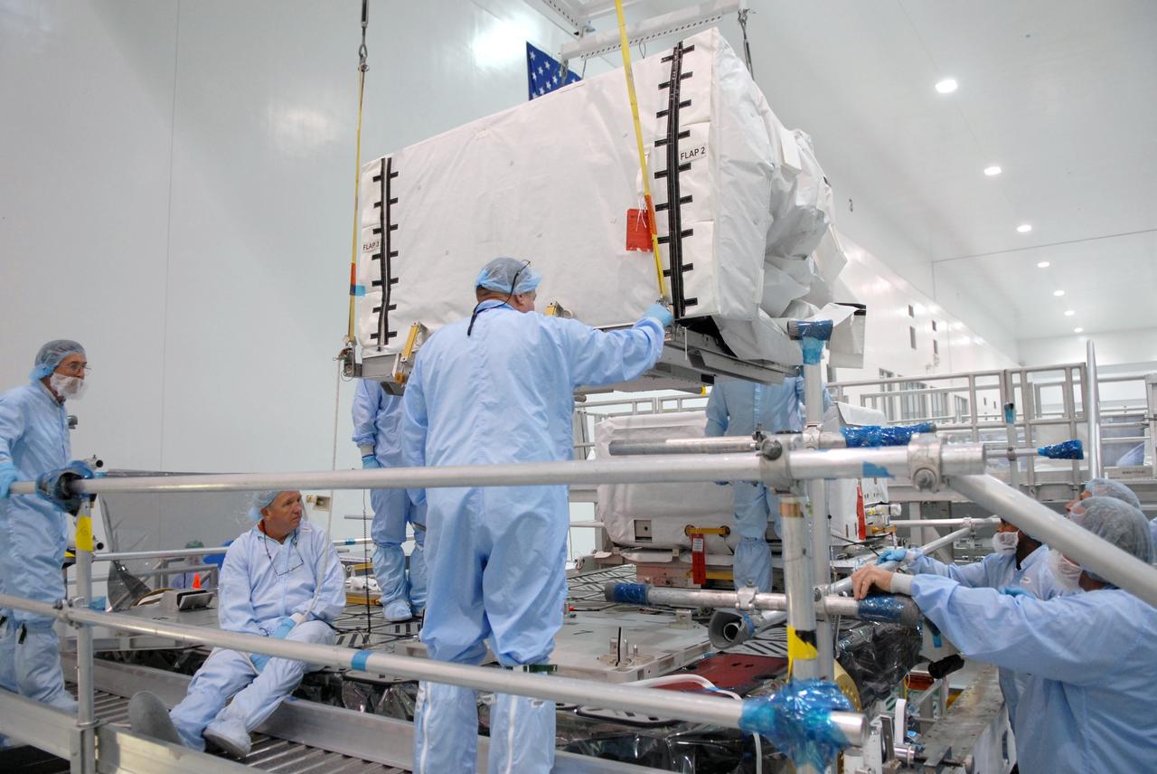 CAPE CANAVERAL, Fla. – In the space Station Processing Facility at NASA's Kennedy Space Center in Florida, the pump module orbital replacement unit is lowered toward the Express Logistics Carrier 1, or ELC-1, for installation. The carrier is part of the STS-129 payload on space shuttle Atlantis, which will deliver to the International Space Station two spare gyroscopes, two nitrogen tank assemblies, two pump modules, an ammonia tank assembly and a spare latching end effector for the station's robotic arm. STS-129 is targeted to launch Nov. 12. Photo credit: NASA/Jim Grossmann