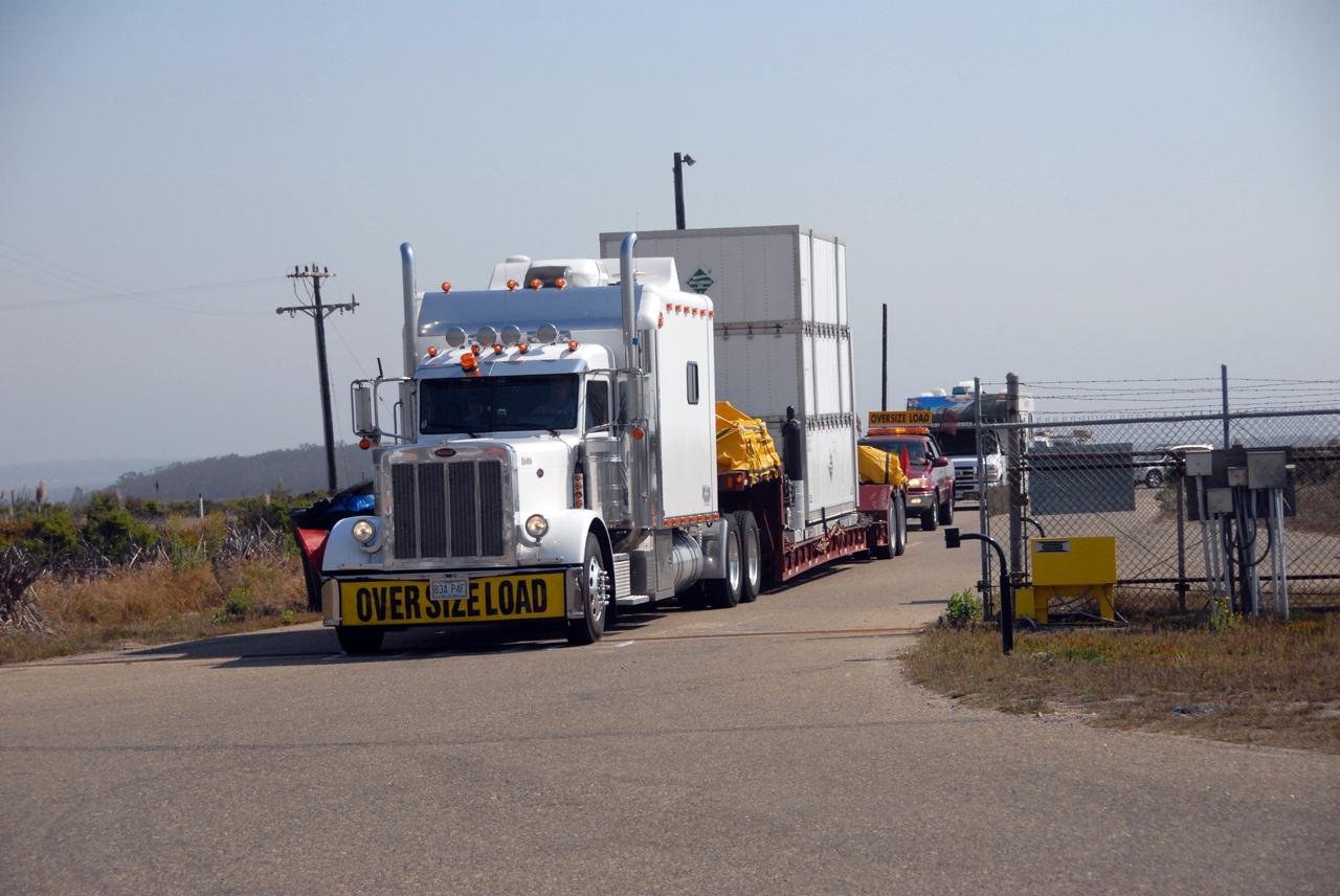 VANDENBERG AIR FORCE BASE, Calif. -- The truck carrying NASA's Wide-field Infrared Survey Explorer, or WISE, spacecraft arrives at Vandenberg Air Force Base in California. It will be taken to the Astrotech payload processing facility. The satellite will survey the entire sky at infrared wavelengths, creating a cosmic clearinghouse of hundreds of millions of objects, which will be catalogued, providing a vast storehouse of knowledge about the solar system, the Milky Way, and the universe. Launch is scheduled no earlier than Dec. 10. Photo credit: NASA/VAFB