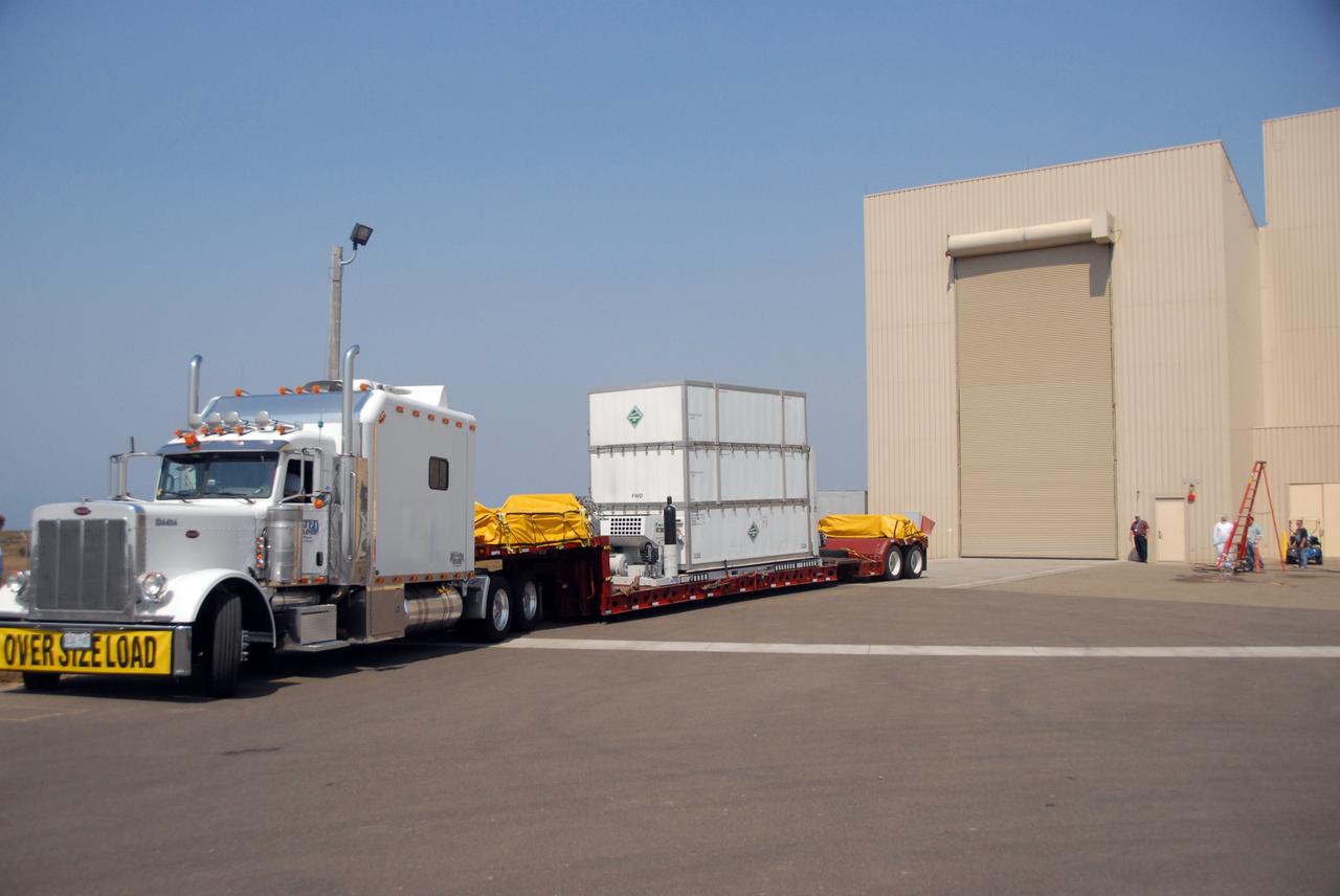 VANDENBERG AIR FORCE BASE, Calif. -- The truck carrying NASA's Wide-field Infrared Survey Explorer, or WISE, spacecraft arrives at the Astrotech payload processing facility on Vandenberg Air Force Base in California. The satellite will survey the entire sky at infrared wavelengths, creating a cosmic clearinghouse of hundreds of millions of objects, which will be catalogued, providing a vast storehouse of knowledge about the solar system, the Milky Way, and the universe. Launch is scheduled no earlier than Dec. 10. Photo credit: NASA/VAFB