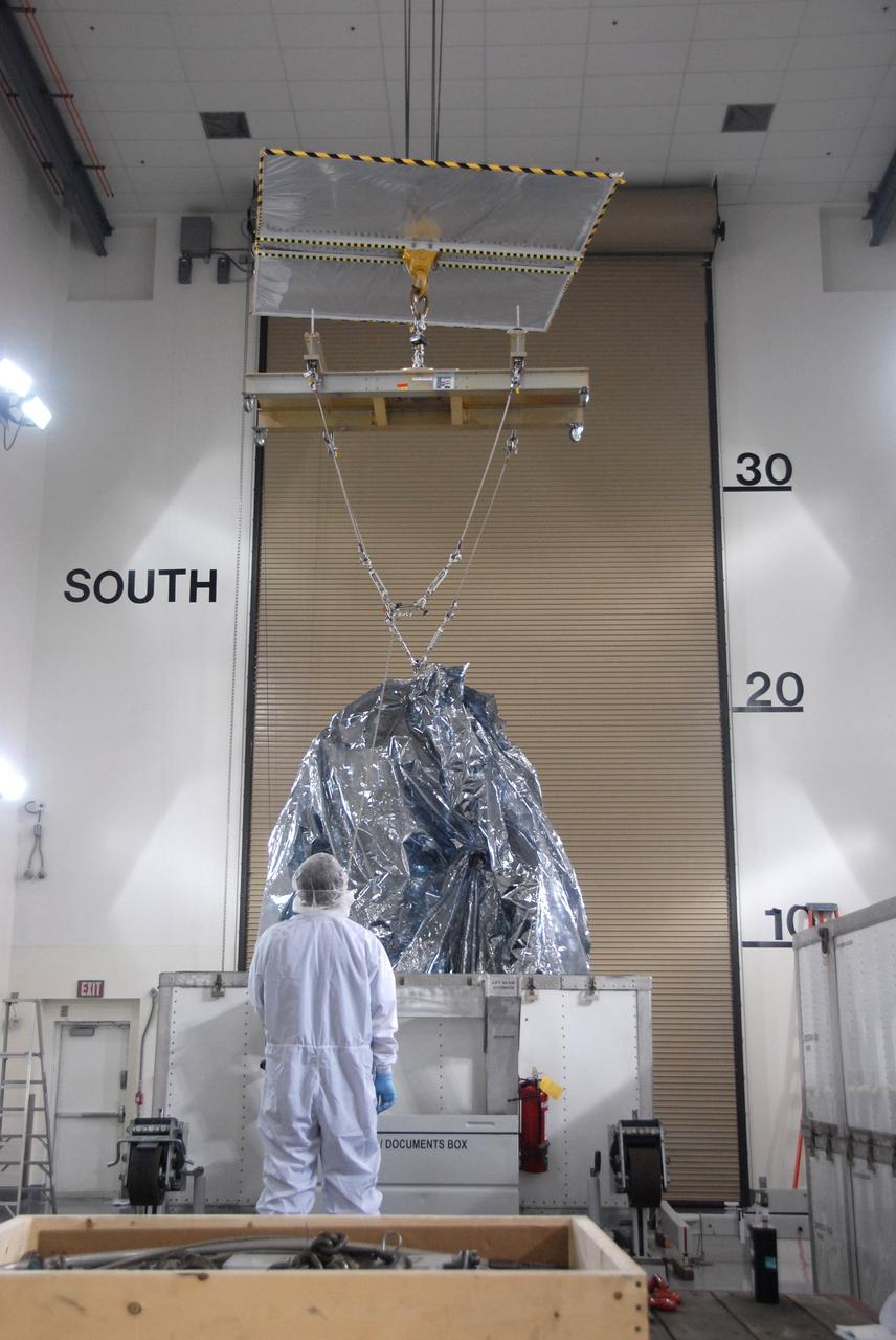 VANDENBERG AIR FORCE BASE, Calif. -- In the Astrotech payload processing facility at Vandenberg Air Force Base in California, NASA's Wide-field Infrared Survey Explorer, or WISE, spacecraft is lifted out of the bottom of the shipping container. The satellite will survey the entire sky at infrared wavelengths, creating a cosmic clearinghouse of hundreds of millions of objects,  which will be catalogued, providing a vast storehouse of knowledge about the solar system, the Milky Way, and the universe. Launch is scheduled no earlier than Dec. 10.  Photo credit: NASA/Doug Kolkow, VAFB