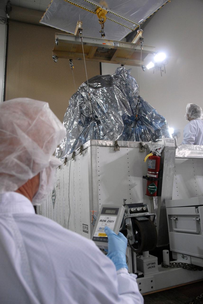 VANDENBERG AIR FORCE BASE, Calif. -- In the Astrotech payload processing facility at Vandenberg Air Force Base in California, NASA's Wide-field Infrared Survey Explorer, or WISE, spacecraft is lifted out of the bottom of the shipping container. The satellite will survey the entire sky at infrared wavelengths, creating a cosmic clearinghouse of hundreds of millions of objects, which will be catalogued, providing a vast storehouse of knowledge about the solar system, the Milky Way, and the universe. Launch is scheduled no earlier than Dec. 10. Photo credit: NASA/Doug Kolkow, VAFB