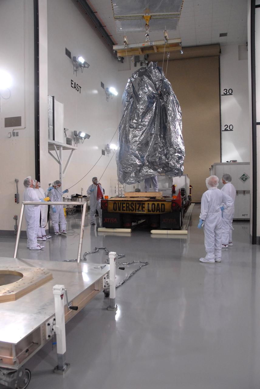 VANDENBERG AIR FORCE BASE, Calif. -- In the Astrotech payload processing facility at Vandenberg Air Force Base in California, NASA's Wide-field Infrared Survey Explorer, or WISE, spacecraft is moved toward a stand seen at front left. The satellite will survey the entire sky at infrared wavelengths, creating a cosmic clearinghouse of hundreds of millions of objects, which will be catalogued, providing a vast storehouse of knowledge about the solar system, the Milky Way, and the universe. Launch is scheduled no earlier than Dec. 10. Photo credit: NASA/Doug Kolkow, VAFB