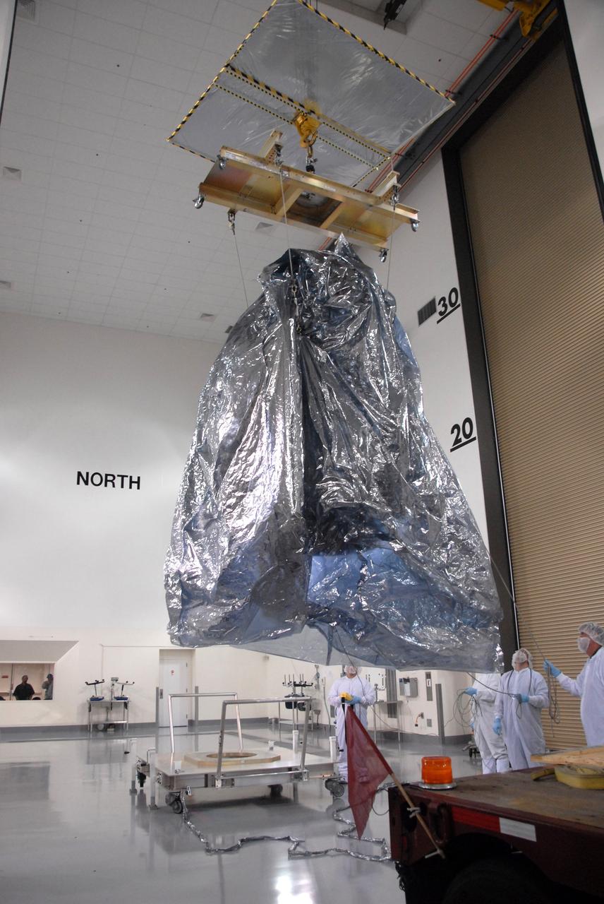 VANDENBERG AIR FORCE BASE, Calif. -- In the Astrotech payload processing facility at Vandenberg Air Force Base in California, NASA's Wide-field Infrared Survey Explorer, or WISE, spacecraft is moved toward a stand seen at bottom center. The satellite will survey the entire sky at infrared wavelengths, creating a cosmic clearinghouse of hundreds of millions of objects, which will be catalogued, providing a vast storehouse of knowledge about the solar system, the Milky Way, and the universe. Launch is scheduled no earlier than Dec. 10. Photo credit: NASA/Doug Kolkow, VAFB