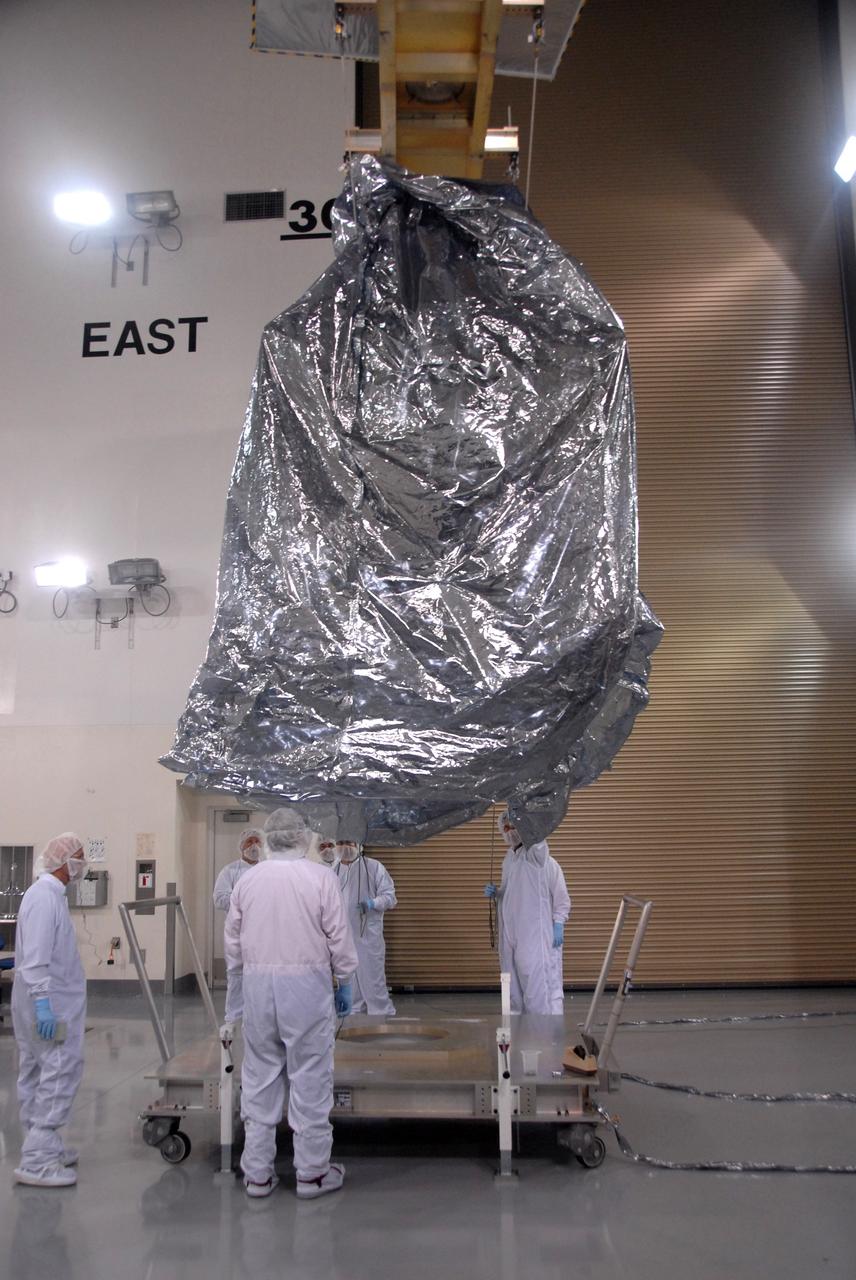 VANDENBERG AIR FORCE BASE, Calif. -- In the Astrotech payload processing facility at Vandenberg Air Force Base in California, NASA's Wide-field Infrared Survey Explorer, or WISE, spacecraft is lowered toward a stand.  The satellite will survey the entire sky at infrared wavelengths, creating a cosmic clearinghouse of hundreds of millions of objects,  which will be catalogued, providing a vast storehouse of knowledge about the solar system, the Milky Way, and the universe. Launch is scheduled no earlier than Dec. 10.  Photo credit: NASA/Doug Kolkow, VAFB