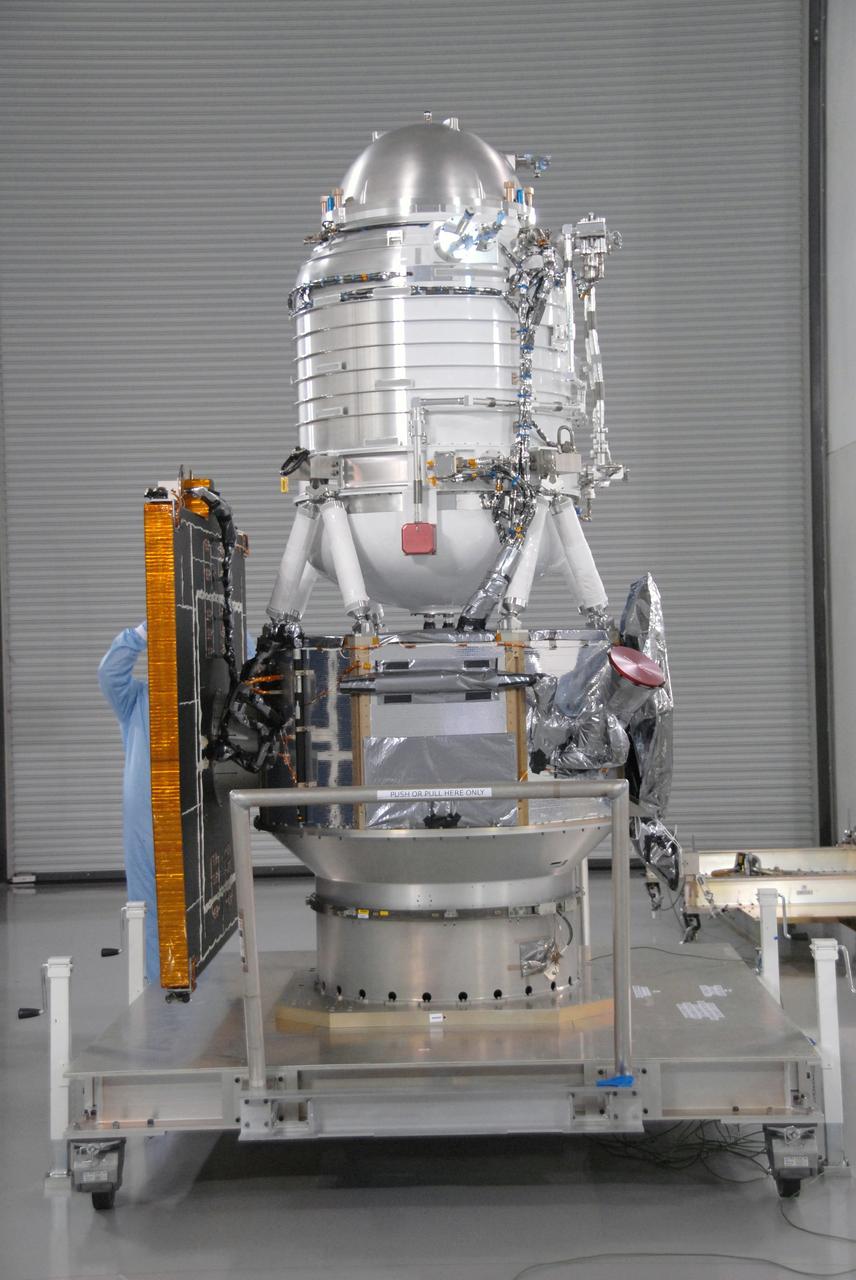 VANDENBERG AIR FORCE BASE, Calif. -- At Vandenberg Air Force Base's Astrotech processing facility in California, workers prepare to move NASA's Wide-field Infrared Survey Explorer, or WISE, spacecraft from the travel dolly to a work stand. The satellite will survey the entire sky at infrared wavelengths, creating a cosmic clearinghouse of hundreds of millions of objects,  which will be catalogued, providing a vast storehouse of knowledge about the solar system, the Milky Way, and the universe. Launch is scheduled no earlier than Dec. 10.  Photo credit: NASA/Moore, VAFB