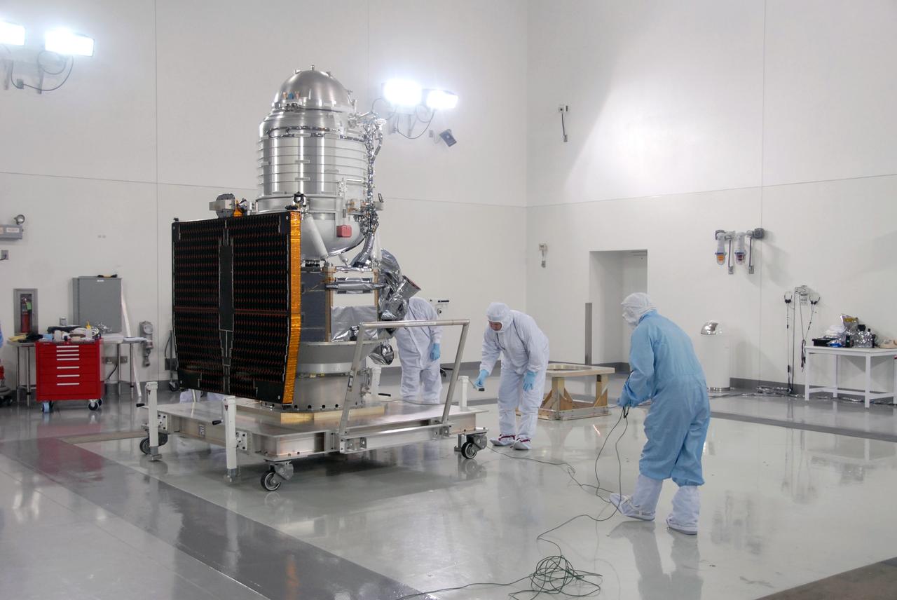 VANDENBERG AIR FORCE BASE, Calif. -- At Vandenberg Air Force Base's Astrotech processing facility in California, workers prepare NASA's Wide-field Infrared Survey Explorer, or WISE, spacecraft for its move from the travel dolly to a work stand. The satellite will survey the entire sky at infrared wavelengths, creating a cosmic clearinghouse of hundreds of millions of objects,  which will be catalogued, providing a vast storehouse of knowledge about the solar system, the Milky Way, and the universe. Launch is scheduled no earlier than Dec. 10.  Photo credit: NASA/Moore, VAFB