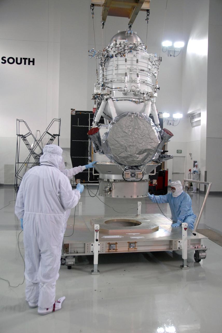 VANDENBERG AIR FORCE BASE, Calif. -- At Vandenberg Air Force Base's Astrotech processing facility in California, workers check NASA's Wide-field Infrared Survey Explorer, or WISE, spacecraft as it is lifted from its travel dolly.  WISE will be moved to a work stand. The satellite will survey the entire sky at infrared wavelengths, creating a cosmic clearinghouse of hundreds of millions of objects,  which will be catalogued, providing a vast storehouse of knowledge about the solar system, the Milky Way, and the universe. Launch is scheduled no earlier than Dec. 10.  Photo credit: NASA/Moore, VAFB