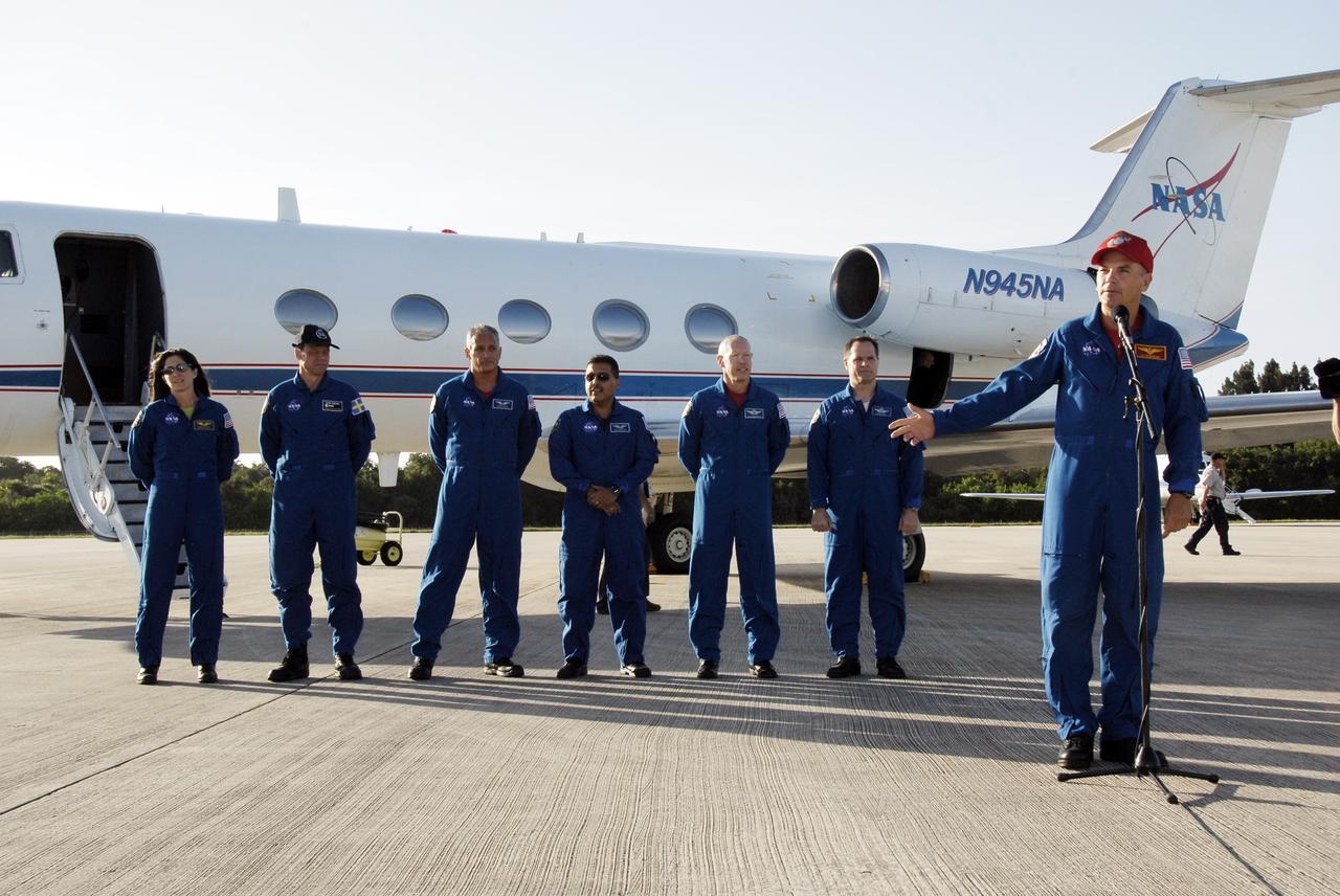 CAPE CANAVERAL, Fla. – The astronauts for space shuttle Discovery’s STS-128 mission address the media on hand to witness their arrival at Kennedy Space Center’s Shuttle Landing Facility. The crew arrived aboard the NASA Shuttle Training Aircraft, a modified Gulfstream II jet, at 6:34 p.m. EDT. From left are Mission Specialists Nicole Stott who will remain on the International Space Station as flight engineer for Expedition 20, Swedish astronaut Christer Fuglesang of the European Space Agency, John "Danny" Olivas, Jose Hernandez, and Patrick Forrester; Pilot Kevin Ford; and Commander Rick Sturckow, at microphone. The crew has returned to Kennedy to prepare for launch on Aug. 25 at 1:36 a.m. EDT. The 13-day mission will deliver a new crew member and 33,000 pounds of equipment to the International Space Station. The equipment includes science and storage racks, a freezer to store research samples, a new sleeping compartment and the COLBERT treadmill. Photo credit: NASA/Kim Shiflett