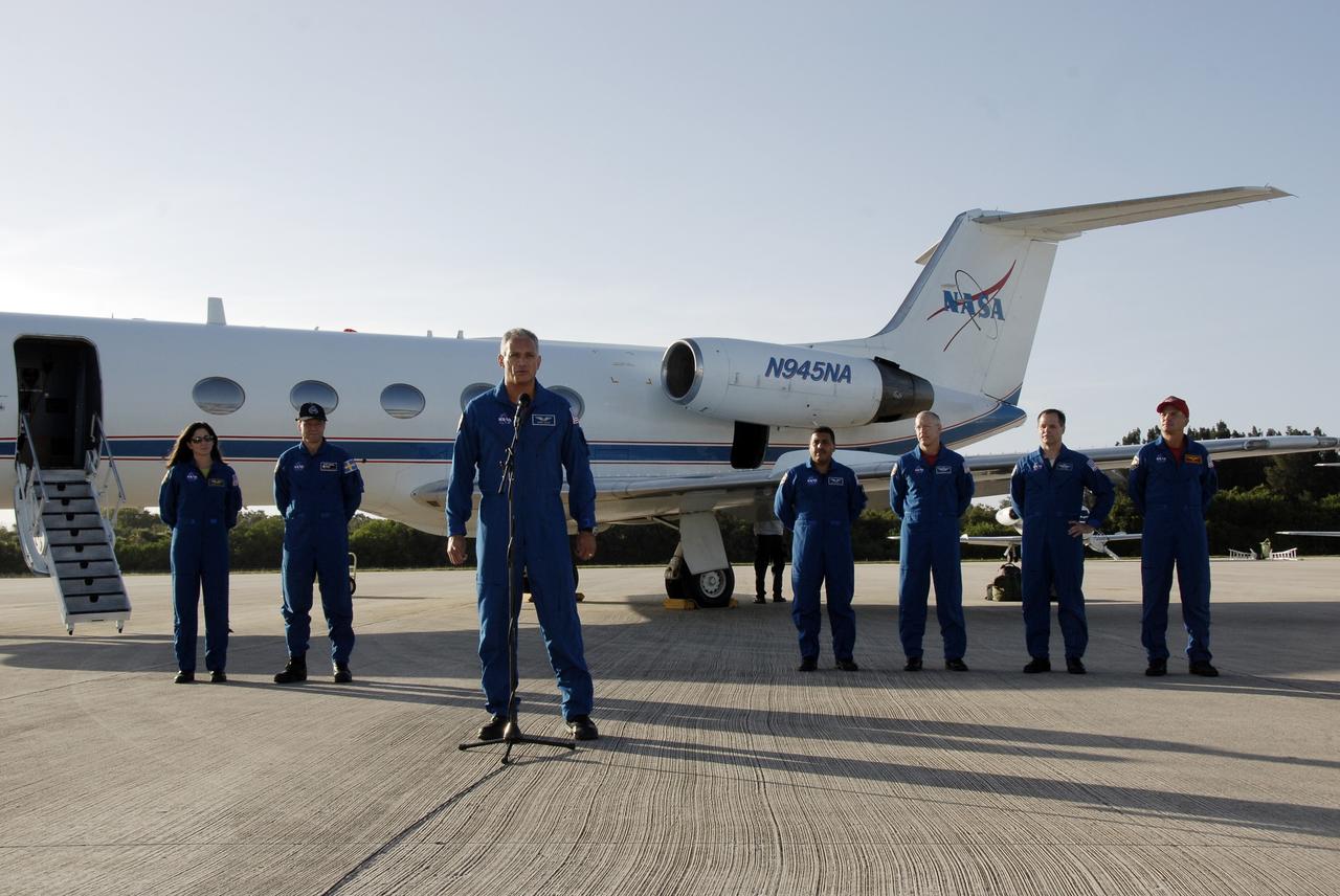 CAPE CANAVERAL, Fla. – The astronauts for space shuttle Discovery’s STS-128 mission address the media on hand to witness their arrival at Kennedy Space Center’s Shuttle Landing Facility. The crew arrived aboard the NASA Shuttle Training Aircraft, a modified Gulfstream II jet, at 6:34 p.m. EDT. From left are Mission Specialists Nicole Stott who will remain on the International Space Station as flight engineer for Expedition 20, Swedish astronaut Christer Fuglesang of the European Space Agency, John "Danny" Olivas (at microphone), Jose Hernandez, and Patrick Forrester; Pilot Kevin Ford; and Commander Rick Sturckow. The crew has returned to Kennedy to prepare for launch on Aug. 25 at 1:36 a.m. EDT. The 13-day mission will deliver a new crew member and 33,000 pounds of equipment to the International Space Station. The equipment includes science and storage racks, a freezer to store research samples, a new sleeping compartment and the COLBERT treadmill. Photo credit: NASA/Kim Shiflett