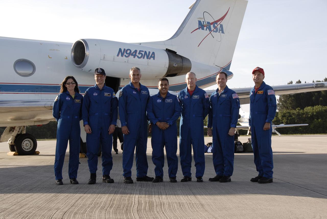 CAPE CANAVERAL, Fla. – The astronauts for space shuttle Discovery’s STS-128 mission pose for a group portrait following their arrival at Kennedy Space Center’s Shuttle Landing Facility at 6:34 p.m. EDT in a NASA Shuttle Training Aircraft. From left are Mission Specialists Nicole Stott who will remain on the International Space Station as flight engineer for Expedition 20, Swedish astronaut Christer Fuglesang of the European Space Agency, John "Danny" Olivas, Jose Hernandez, and Patrick Forrester; Pilot Kevin Ford; and Commander Rick Sturckow. The crew has returned to Kennedy to prepare for launch on Aug. 25 at 1:36 a.m. EDT. The 13-day mission will deliver a new crew member and 33,000 pounds of equipment to the International Space Station. The equipment includes science and storage racks, a freezer to store research samples, a new sleeping compartment and the COLBERT treadmill. Photo credit: NASA/Kim Shiflett