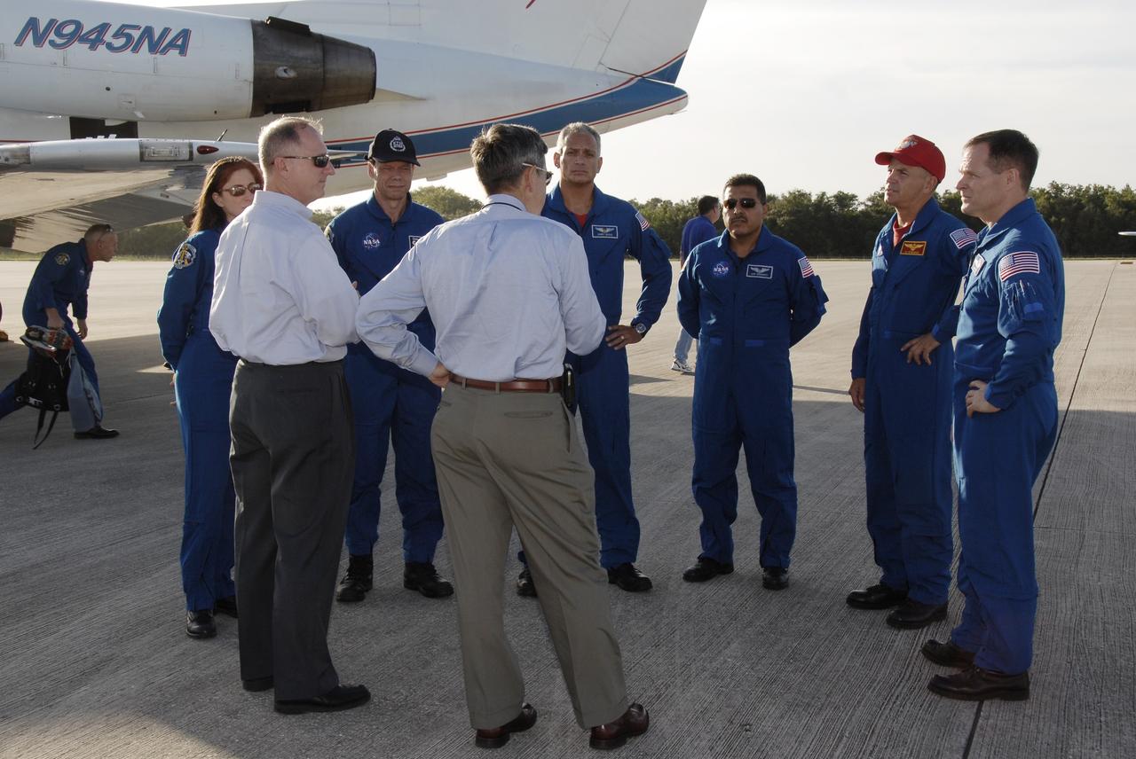 CAPE CANAVERAL, Fla. – Members of space shuttle Discovery's STS-128 crew are welcomed to Kennedy Space Center by STS-128 Launch Director Pete Nickolenko, at left, and Center Director Bob Cabana, a former astronaut himself. The crew arrived in a NASA Shuttle Training Aircraft, a modified Gulfstream II jet, at Kennedy's Shuttle Landing Facility at 6:34 p.m. EDT. The astronauts are, from left, Mission Specialists Patrick Forrester (under the aircraft), Nicole Stott who will remain on the International Space Station as flight engineer for Expedition 20, Swedish astronaut Christer Fuglesang of the European Space Agency, John "Danny" Olivas, and Jose Hernandez; Commander Rick Sturckow; and Pilot Kevin Ford. The crew has returned to Kennedy to prepare for launch on Aug. 25 at 1:36 a.m. EDT. The 13-day mission will deliver a new crew member and 33,000 pounds of equipment to the International Space Station. The equipment includes science and storage racks, a freezer to store research samples, a new sleeping compartment and the COLBERT treadmill. Photo credit: NASA/Kim Shiflett
