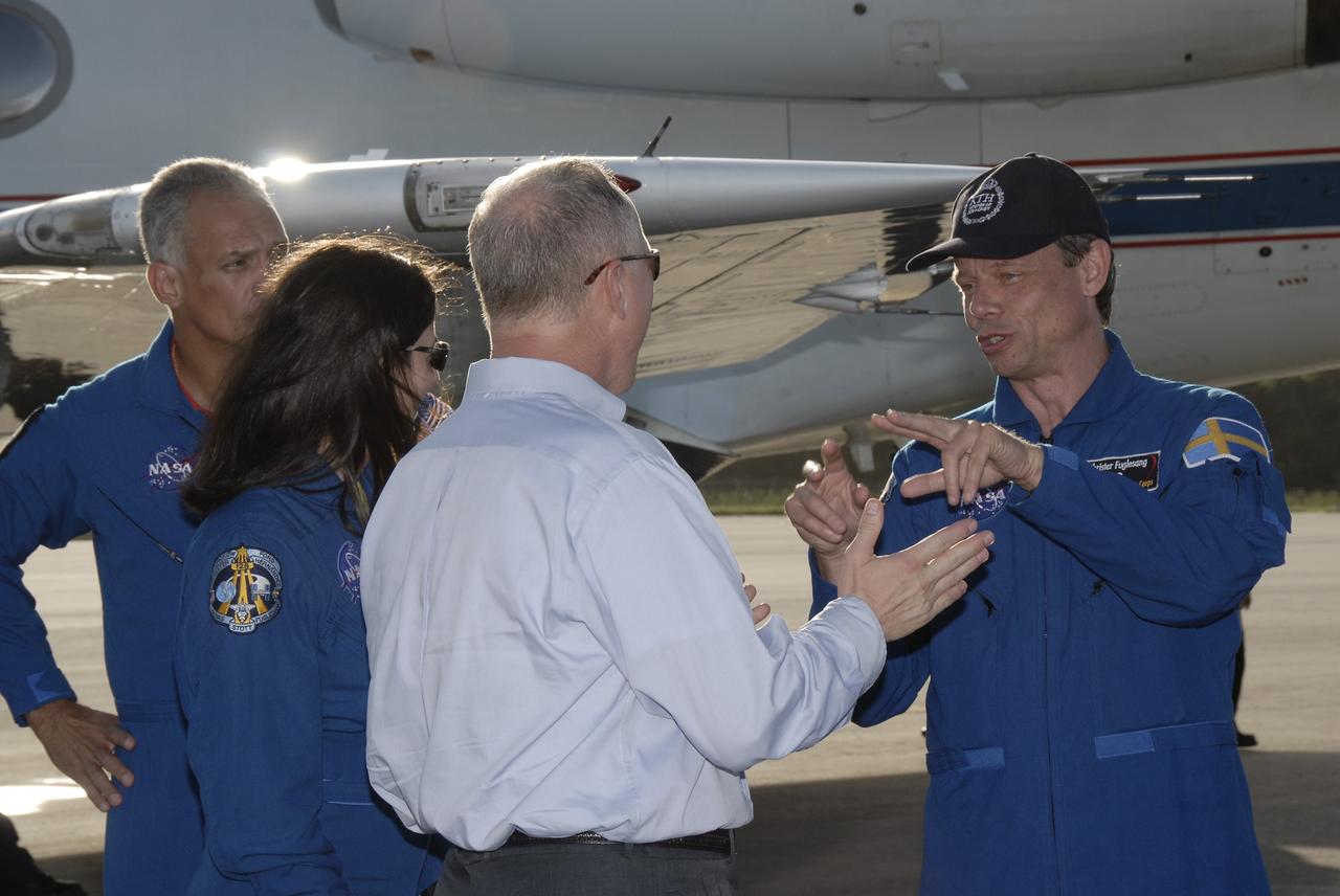 CAPE CANAVERAL, Fla. – STS-128 Launch Director Pete Nickolenko welcomes members of space shuttle Discovery's STS-128 crew to Kennedy Space Center. The crew arrived in a NASA Shuttle Training Aircraft, the modified Gulfstream II jet behind them, at Kennedy's Shuttle Landing Facility at 6:34 p.m. EDT. The astronauts are, from left, Mission Specialists John "Danny" Olivas, Nicole Stott who will remain on the International Space Station as flight engineer for Expedition 20, and Swedish astronaut Christer Fuglesang of the European Space Agency. The crew has returned to Kennedy to prepare for launch on Aug. 25 at 1:36 a.m. EDT. The 13-day mission will deliver a new crew member and 33,000 pounds of equipment to the International Space Station. The equipment includes science and storage racks, a freezer to store research samples, a new sleeping compartment and the COLBERT treadmill. Photo credit: NASA/Kim Shiflett