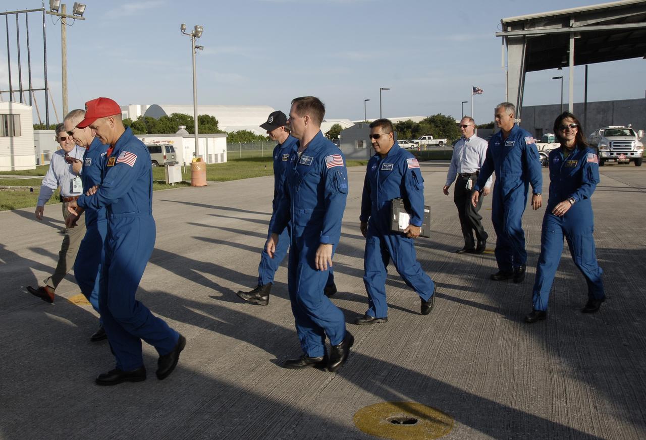 CAPE CANAVERAL, Fla. – At NASA's Kennedy Space Center, members of space shuttle Discovery's STS-128 crew depart the Shuttle Landing Facility for crew quarters in the Operations and Checkout Building. The crew arrived in a NASA Shuttle Training Aircraft at Kennedy's Shuttle Landing Facility at 6:34 p.m. EDT. From left are Kennedy's Center Director Bob Cabana, a former astronaut himself; Mission Specialist Patrick Forrester; Commander Rick Sturckow; Mission Specialist Christer Fuglesang, a Swedish astronaut with the European Space Agency; Pilot Kevin Ford; Mission Specialist Jose Hernandez; STS-128 Launch Director Pete Nickolenko; and Mission Specialists John "Danny" Olivas and Nicole Stott who will remain on the International Space Station as flight engineer for Expedition 20. The crew has returned to Kennedy to prepare for launch on Aug. 25 at 1:36 a.m. EDT. The 13-day mission will deliver a new crew member and 33,000 pounds of equipment to the International Space Station. The equipment includes science and storage racks, a freezer to store research samples, a new sleeping compartment and the COLBERT treadmill. Photo credit: NASA/Kim Shiflett