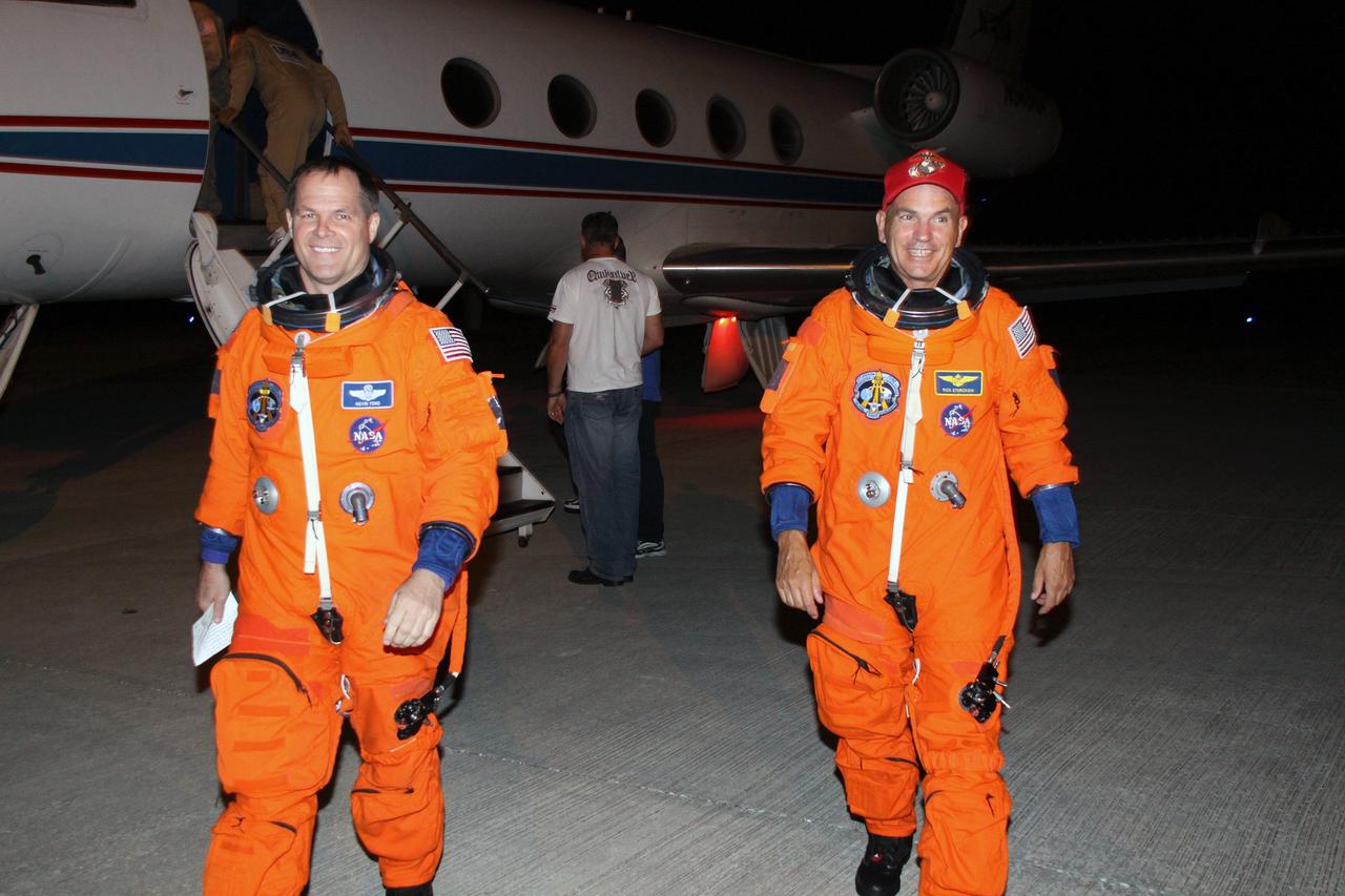 CAPE CANAVERAL, Fla. – STS-128 Commander Rick Sturckow (right) and Pilot Kevin Ford walk across NASA Kennedy Space Center's Shuttle Landing Facility after completing practice shuttle landings as preparation for space shuttle Discovery's launch Aug. 25 on the STS-128 mission. The 13-day mission will deliver a new crew member and 33,000 pounds of equipment to the International Space Station. The equipment includes science and storage racks, a freezer to store research samples, a new sleeping compartment and the COLBERT treadmill. Photo credit: NASA/Troy Cryder