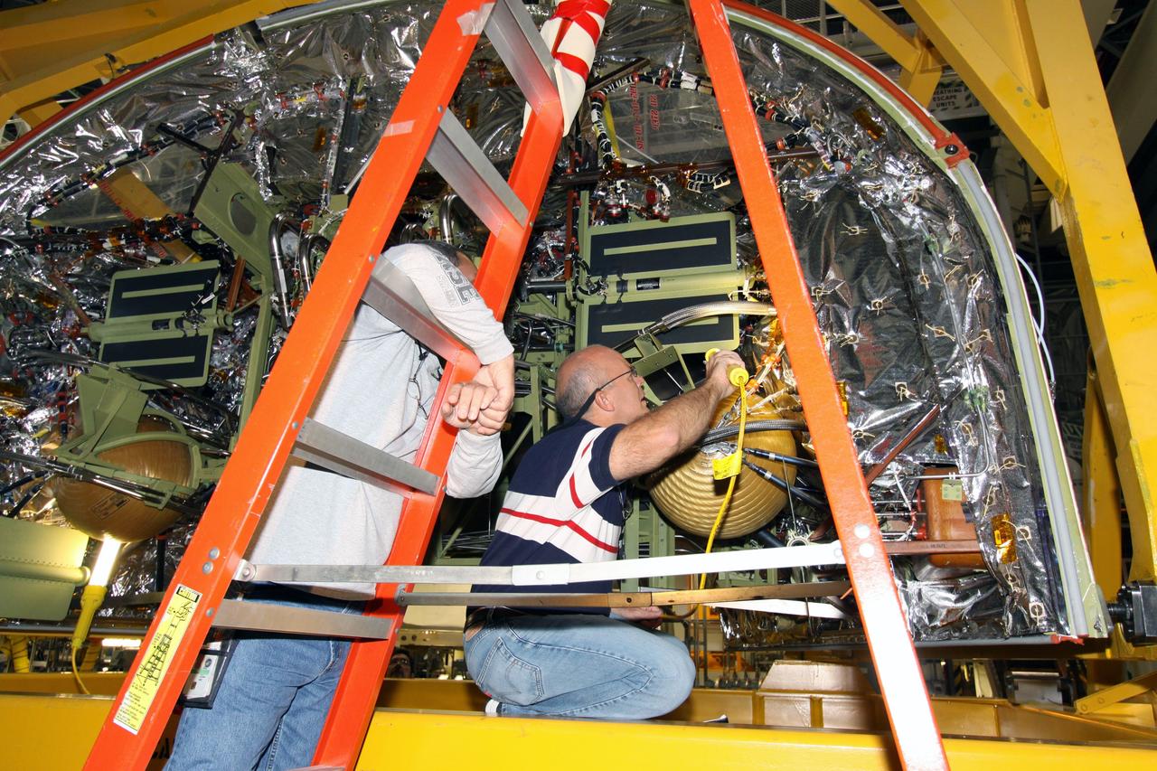 CAPE CANAVERAL, Fla. – In NASA Kennedy Space Center's Orbiter Processing Facility 2, workers begin removing the forward reaction control system, or FRCS, from space shuttle Endeavour's forward fuselage nose area. The FRCS provides the thrust for attitude (rotational) maneuvers (pitch, yaw and roll) and for small velocity changes along the orbiter axis (translation maneuvers). Endeavour is designated as the shuttle for the STS-130 mission, targeted for launch in February 2010. Photo credit: NASA/Jack Pfaller