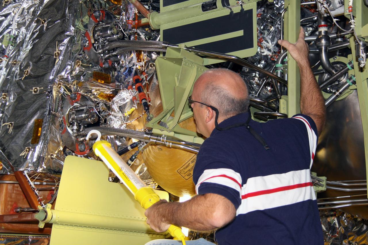 CAPE CANAVERAL, Fla. – In NASA Kennedy Space Center's Orbiter Processing Facility 2, a worker removes the forward reaction control system, or FRCS, from space shuttle Endeavour's forward fuselage nose area. The FRCS provides the thrust for attitude (rotational) maneuvers (pitch, yaw and roll) and for small velocity changes along the orbiter axis (translation maneuvers). Endeavour is designated as the shuttle for the STS-130 mission, targeted for launch in February 2010. Photo credit: NASA/Jack Pfaller
