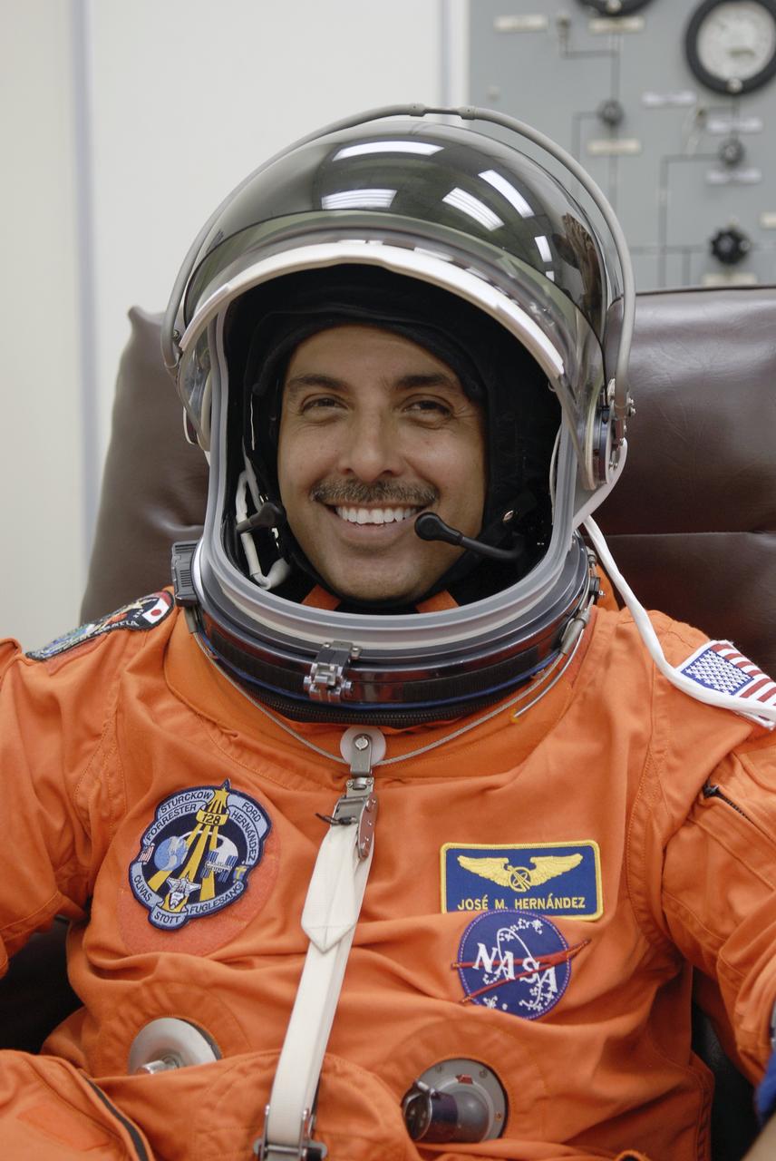 CAPE CANAVERAL, Fla. – STS-128 Mission Specialist Jose Hernandez makes a fit-check on his launch-and-entry suit to prepare for launch.  He and the rest of the crew are scheduled to lift off on space shuttle Discovery at 1:36 a.m. EDT Aug. 25.   The 13-day mission will deliver a new crew member and 33,000 pounds of equipment to the International Space Station. The equipment includes science and storage racks, a freezer to store research samples, a new sleeping compartment and the COLBERT treadmill.  Photo credit: NASA/Kim Shiflett