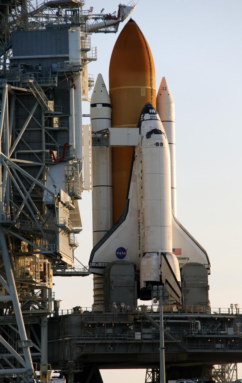 CAPE CANAVERAL, Fla. – On Launch Pad 39A at NASA's Kennedy Space Center in Florida, space shuttle Discovery is revealed during sunrise after the rollback of the rotating service structure, or RSS. On top of the external fuel tank is the oxygen vent hood, called the "beanie cap," which is designed to vent gaseous oxygen vapors away from the shuttle. The rollback is preparation for Discovery's scheduled 1:36 a.m. EDT liftoff Aug. 25 with a crew of seven on the STS-128 mission. The service structure provides weather protection and access to the space shuttle at the launch pad. The 13-day mission will deliver a new crew member and 33,000 pounds of equipment to the International Space Station. The equipment includes science and storage racks, a freezer to store research samples, a new sleeping compartment and the COLBERT treadmill. STS-128 will be Discovery's 37th mission and the 30th shuttle flight dedicated to station assembly and maintenance. Photo credit: NASA/Troy Cryder