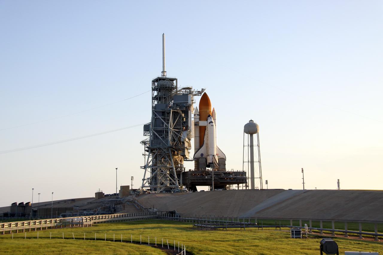 CAPE CANAVERAL, Fla. – After rollback of the rotating service structure, or RSS, on Launch Pad 39A at NASA's Kennedy Space Center in Florida, space shuttle Discovery is closer to launch on the STS-128 mission. Against the shuttle's cockpit is seen the White Room at the end of the orbiter access arm. The White Room provides the astronauts entry into the shuttle. Discovery sits on the mobile launcher platform, which straddles the flame trench below. On either side of the engine nozzles are the tail masts, which provide several umbilical connections to the orbiter, including a liquid-oxygen line through one and a liquid-hydrogen line through another. Liftoff is scheduled for 1:36 a.m. EDT Aug. 25.The service structure provides weather protection and access to the space shuttle at the launch pad. The 13-day mission will deliver a new crew member and 33,000 pounds of equipment to the International Space Station. The equipment includes science and storage racks, a freezer to store research samples, a new sleeping compartment and the COLBERT treadmill. STS-128 will be Discovery's 37th mission and the 30th shuttle flight dedicated to station assembly and maintenance. Photo credit: NASA/Troy Cryder