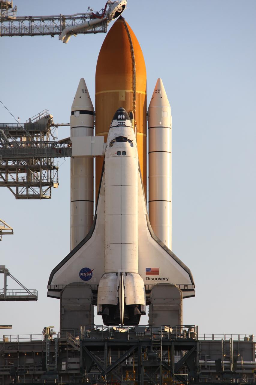 CAPE CANAVERAL, Fla. – After rollback of the rotating service structure, or RSS, on Launch Pad 39A at NASA's Kennedy Space Center in Florida, space shuttle Discovery is closer to launch on the STS-128 mission. Against the shuttle's cockpit is seen the White Room at the end of the orbiter access arm. The White Room provides the astronauts entry into the shuttle. Discovery sits on the mobile launcher platform, which straddles the flame trench below. On either side of the engine nozzles are the tail masts, which provide several umbilical connections to the orbiter, including a liquid-oxygen line through one and a liquid-hydrogen line through another. Liftoff is scheduled for 1:36 a.m. EDT Aug. 25.The service structure provides weather protection and access to the space shuttle at the launch pad. The 13-day mission will deliver a new crew member and 33,000 pounds of equipment to the International Space Station. The equipment includes science and storage racks, a freezer to store research samples, a new sleeping compartment and the COLBERT treadmill. STS-128 will be Discovery's 37th mission and the 30th shuttle flight dedicated to station assembly and maintenance. Photo credit: NASA/Troy Cryder
