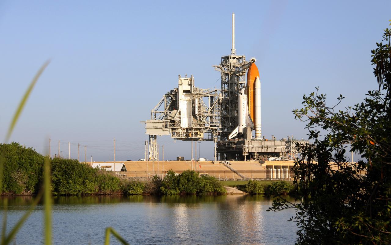 CAPE CANAVERAL, Fla. – Space Shuttle Discovery sits on Launch Pad 39A at NASA’s Kennedy Space Center in Florida, after rollback of the rotating service structure, or RSS. The oxygen vent hood, called the “beanie cap,” is positioned above the external fuel tank. It is designed to vent gaseous oxygen vapors away from the shuttle. The rollback is preparation for Discovery’s scheduled 1:36 a.m. EDT liftoff Aug. 25 on the STS-128 mission with a crew of seven. First motion was at 5:06 a.m. EDT and completed at 5:46 a.m. EDT. The service structure provides weather protection and access to the space shuttle at the launch pad. The 13-day mission will deliver a new crew member and 33,000 pounds of equipment to the International Space Station. The equipment includes science and storage racks, a freezer to store research samples, a new sleeping compartment and the COLBERT treadmill. STS-128 will be Discovery's 37th mission and the 30th shuttle flight dedicated to station assembly and maintenance. Photo credit: NASA/Troy Cryder