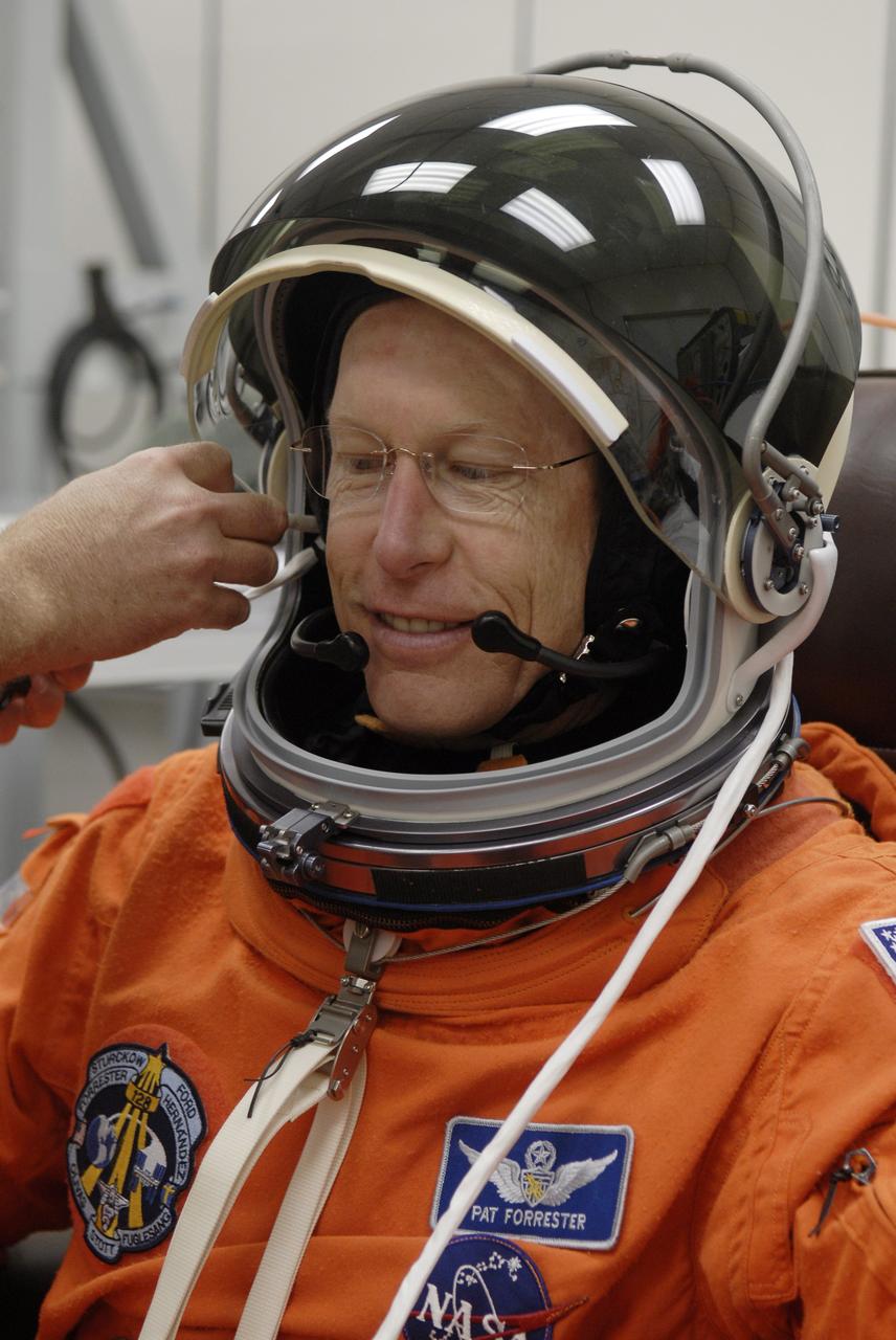 CAPE CANAVERAL, Fla. – In the Operations and Checkout Building at NASA's Kennedy Space Center in Florida, STS-128 crew members put on their launch-and-entry suits before heading to the Astrovan for the 3.4-mile drive to Launch Pad 39A. There, crew members will complete their suitup and enter space shuttle Discovery for the 1:36 a.m. EDT liftoff. Seen here, Mission Specialist Patrick Forrester has his helmet communications system connected. The 13-day mission will deliver more than 7 tons of supplies, science racks and equipment, as well as additional environmental hardware to sustain six crew members on the International Space Station. The equipment includes a freezer to store research samples, a new sleeping compartment and the COLBERT treadmill. The mission is the 128th in the Space Shuttle Program, the 37th flight of Discovery and the 30th station assembly flight. Photo credit: NASA/Kim Shiflett