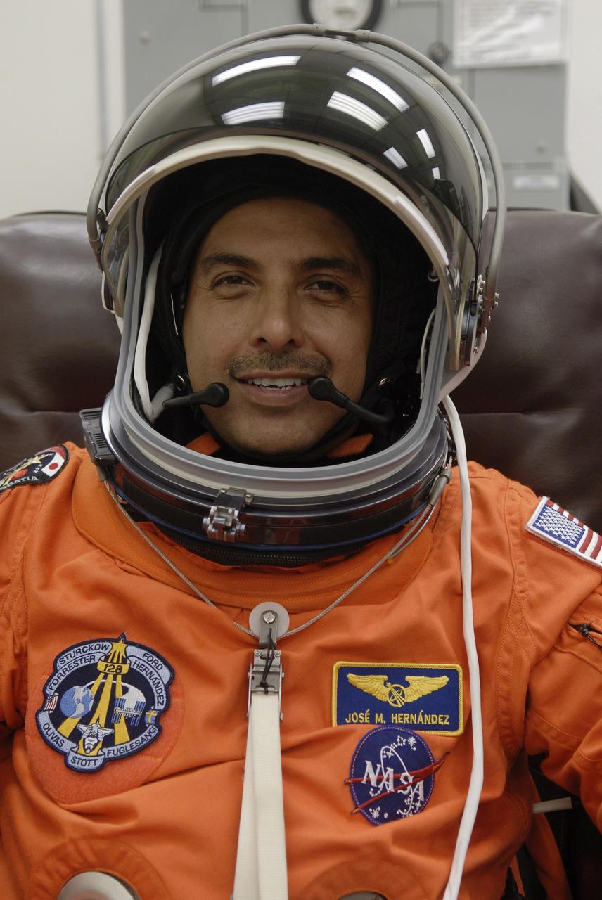 CAPE CANAVERAL, Fla. –In the Operations and Checkout Building at NASA's Kennedy Space Center in Florida, STS-128 crew members put on their launch-and-entry suits before heading to the Astrovan for the 3.4-mile drive to Launch Pad 39A.  There, crew members will complete their suitup and enter space shuttle Discovery for the 1:36 a.m. EDT liftoff. Seen here is Mission Specialist Jose Hernandez, who is making his first shuttle flight. The 13-day mission will deliver more than 7 tons of supplies, science racks and equipment, as well as additional environmental hardware to sustain six crew members on the International Space Station. The equipment includes a freezer to store research samples, a new sleeping compartment and the COLBERT treadmill.  The mission is the 128th in the Space Shuttle Program, the 37th flight of Discovery and the 30th station assembly flight.  Photo credit: NASA/Kim Shiflett