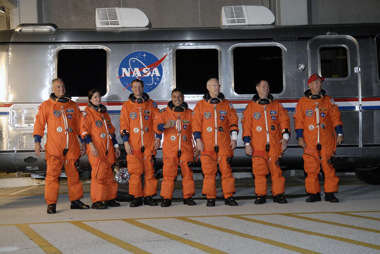 CAPE CANAVERAL, Fla. – The STS-128 crew members pause in front of the Astrovan that will take them to Launch Pad 39A.  From left are Mission Specialists Danny Olivas, Nicole Stott, Christer Fuglesang, Jose Hernandez and Patrick Forrester, Pilot Kevin Ford and Commander Rick Sturckow. At the pad, the astronauts will complete their suitup and enter space shuttle Discovery for the 1:36 a.m. EDT liftoff.  The 13-day mission will deliver more than 7 tons of supplies, science racks and equipment, as well as additional environmental hardware to sustain six crew members on the International Space Station. The equipment includes a freezer to store research samples, a new sleeping compartment and the COLBERT treadmill.  The mission is the 128th in the Space Shuttle Program, the 37th flight of Discovery and the 30th station assembly flight.  Photo credit: NASA/Kim Shiflett