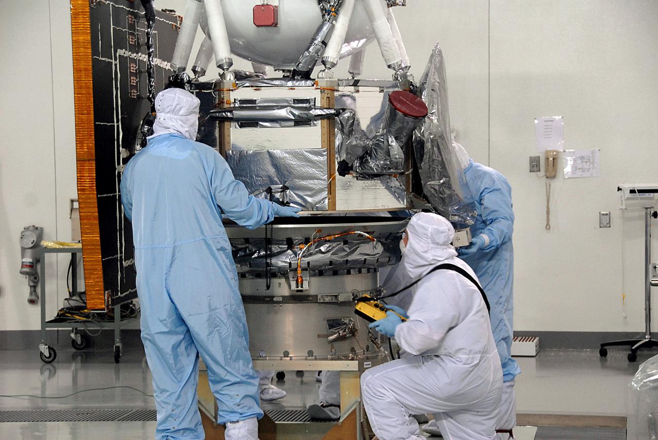 VANDENBERG AIR FORCE BASE, Calif. -- At Vandenberg Air Force Base's Astrotech processing facility in California, NASA's Wide-field Infrared Survey Explorer, or WISE, spacecraft is lowered onto the flight conical adapter and test stand. The satellite will survey the entire sky at infrared wavelengths, creating a cosmic clearinghouse of hundreds of millions of objects, which will be catalogued, providing a vast storehouse of knowledge about the solar system, the Milky Way, and the universe. Launch is scheduled no earlier than Dec. 7. Photo credit: NASA/Doug Kolkow