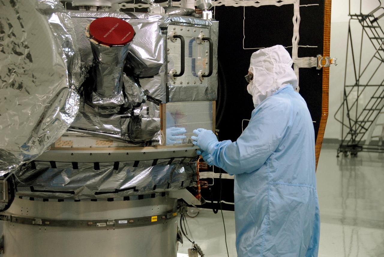VANDENBERG AIR FORCE BASE, Calif. -- At Vandenberg Air Force Base's Astrotech processing facility in California, a technician fastens NASA's Wide-field Infrared Survey Explorer, or WISE, spacecraft onto the flight conical adapter and test stand. The satellite will survey the entire sky at infrared wavelengths, creating a cosmic clearinghouse of hundreds of millions of objects, which will be catalogued, providing a vast storehouse of knowledge about the solar system, the Milky Way, and the universe. Launch is scheduled no earlier than Dec. 7. Photo credit: NASA/Doug Kolkow