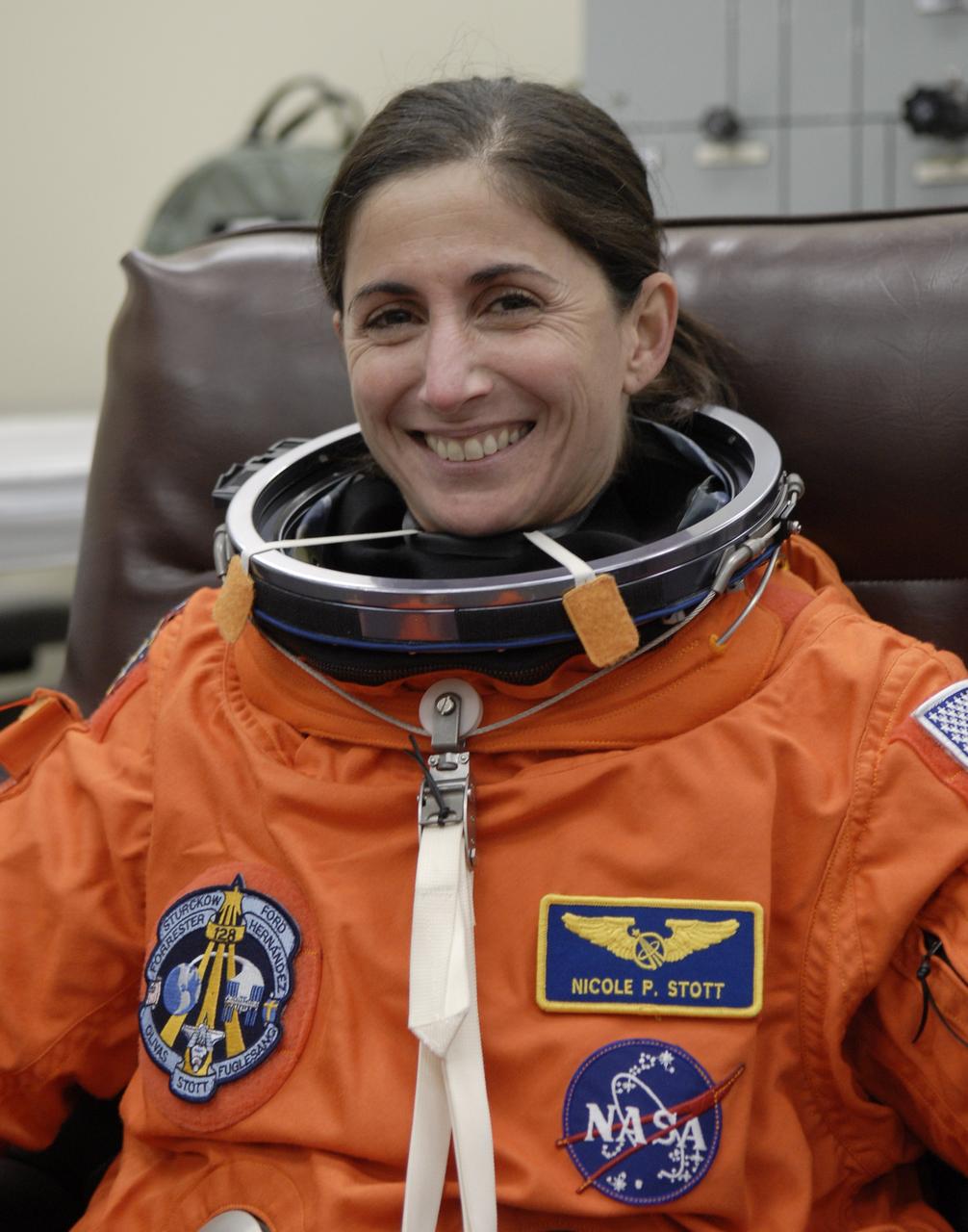 CAPE CANAVERAL, Fla. – In the Operations and Checkout Building at NASA's Kennedy Space Center in Florida, STS-128 crew members put on their launch-and-entry suits before heading to the Astrovan for the 3.4-mile drive to Launch Pad 39A. There, crew members will complete their suit-up and enter space shuttle Discovery for the 11:59 p.m. EDT liftoff. Seen here is Mission Specialist Nicole Stott, who will join the Expedition 20 crew on the International Space Station, replacing flight engineer Tim Kopra. The first launch attempt on Aug. 24 was postponed due to unfavorable weather conditions. The second attempt on Aug. 25 also was postponed due to an issue with a valve in space shuttle Discovery's main propulsion system. The 13-day mission will deliver more than 7 tons of supplies, science racks and equipment, as well as additional environmental hardware to sustain six crew members on the International Space Station. The equipment includes a freezer to store research samples, a new sleeping compartment and the COLBERT treadmill. The mission is the 128th in the Space Shuttle Program, the 37th flight of Discovery and the 30th station assembly flight. Photo credit: NASA/Kim Shiflett