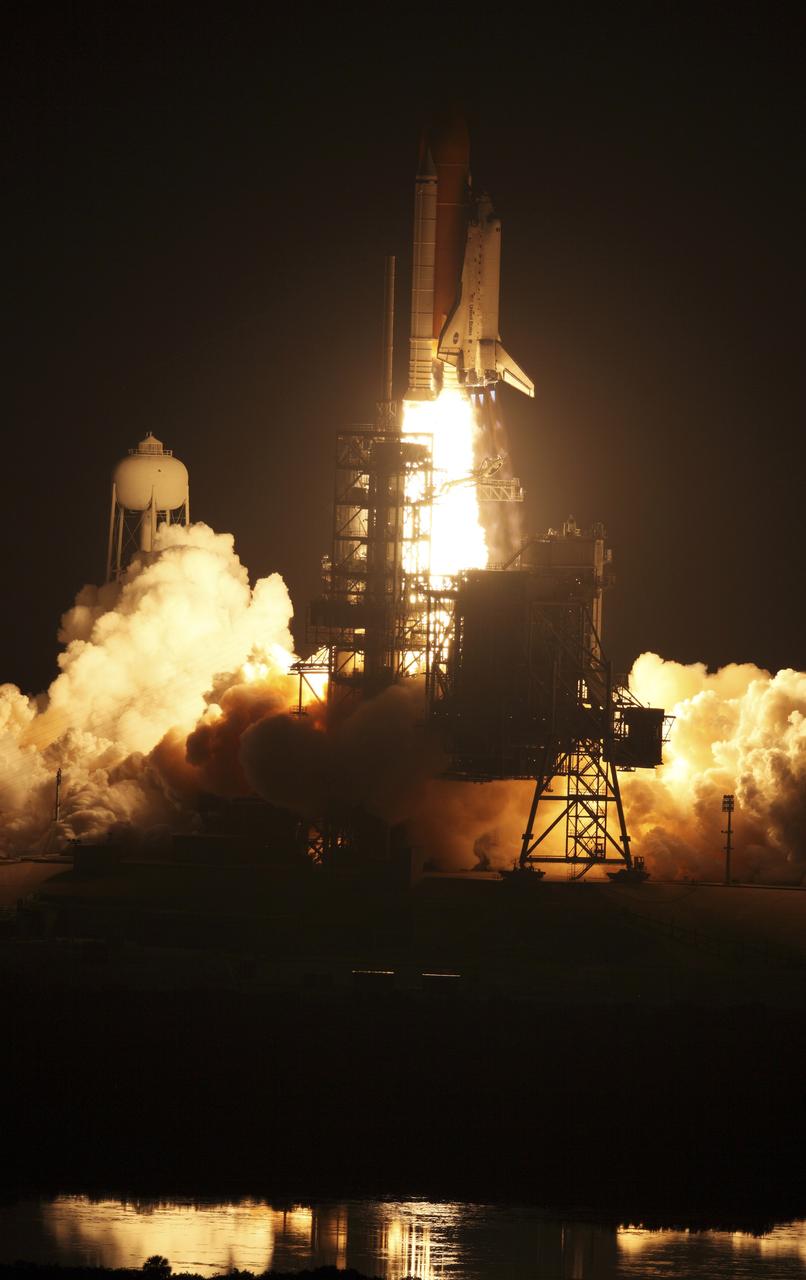 CAPE CANAVERAL, Fla. – At NASA's Kennedy Space Center in Florida, steam and smoke billow in the light from space shuttle Discovery's fiery launch on the STS-128 mission. Liftoff from Launch Pad 39A was on time at 11:59 p.m. EDT. The first launch attempt on Aug. 24 was postponed due to unfavorable weather conditions. The second attempt on Aug. 25 also was postponed due to an issue with a valve in space shuttle Discovery's main propulsion system. The STS-128 mission is the 30th International Space Station assembly flight and the 128th space shuttle flight. The 13-day mission will deliver more than 7 tons of supplies, science racks and equipment, as well as additional environmental hardware to sustain six crew members on the International Space Station. The equipment includes a freezer to store research samples, a new sleeping compartment and the COLBERT treadmill. Photo courtesy of Scott Andrews
