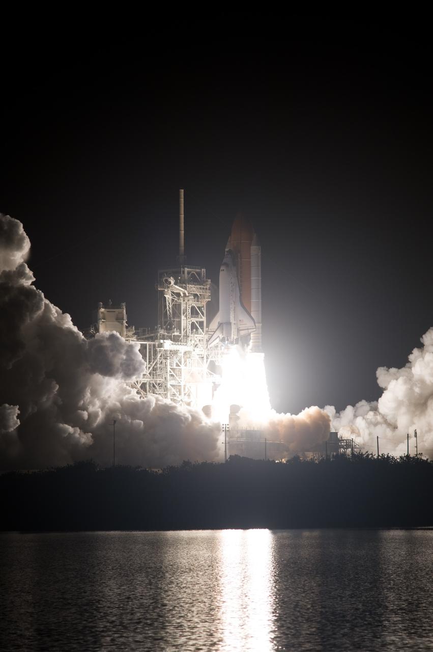 CAPE CANAVERAL, Fla. – Reflected in the water next to Launch Pad 39A at NASA's Kennedy Space Center in Florida, space shuttle Discovery roars toward space on the STS-128 mission. Liftoff from Launch Pad 39A was on time at 11:59 p.m. EDT. The first launch attempt on Aug. 24 was postponed due to unfavorable weather conditions. The second attempt on Aug. 25 also was postponed due to an issue with a valve in space shuttle Discovery's main propulsion system. The STS-128 mission is the 30th International Space Station assembly flight and the 128th space shuttle flight. The 13-day mission will deliver more than 7 tons of supplies, science racks and equipment, as well as additional environmental hardware to sustain six crew members on the International Space Station. The equipment includes a freezer to store research samples, a new sleeping compartment and the COLBERT treadmill. Photo credit: NASA/Sandra Joseph-Kevin O'Connell