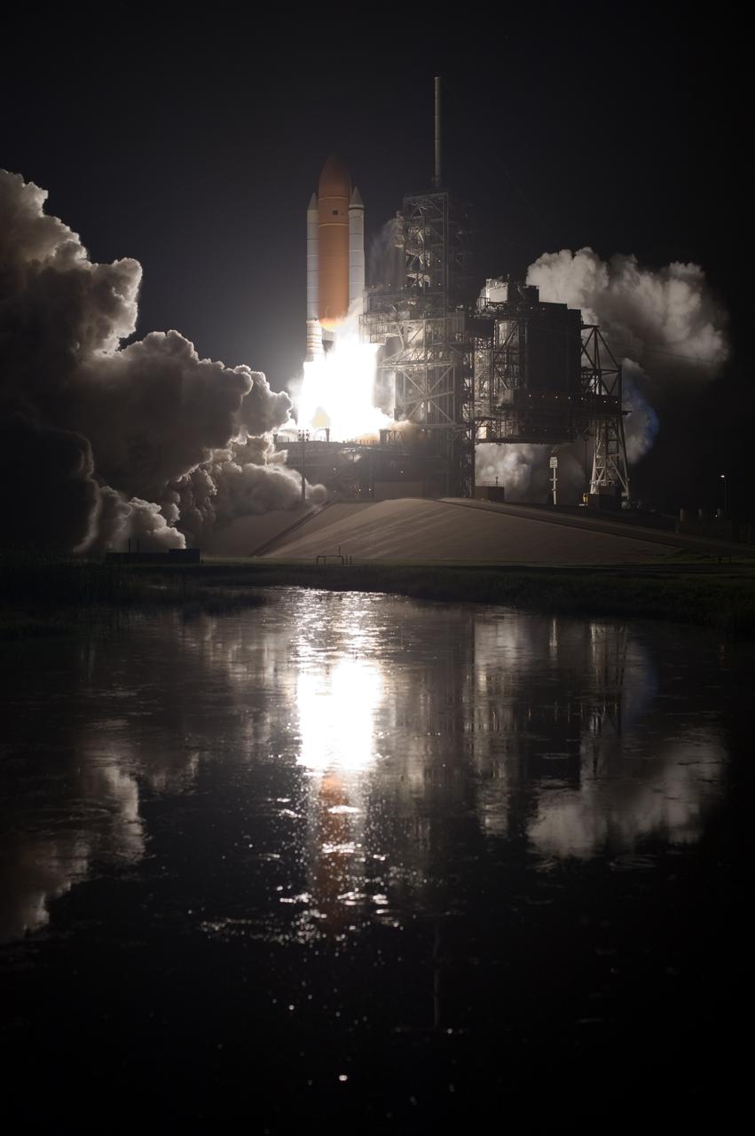 CAPE CANAVERAL, Fla. – The water close to Launch Pad 39A at NASA's Kennedy Space Center in Florida captures the brilliance from launch of space shuttle Discovery on the STS-128 mission. Liftoff from Launch Pad 39A was on time at 11:59 p.m. EDT. The first launch attempt on Aug. 24 was postponed due to unfavorable weather conditions. The second attempt on Aug. 25 also was postponed due to an issue with a valve in space shuttle Discovery's main propulsion system. The STS-128 mission is the 30th International Space Station assembly flight and the 128th space shuttle flight. The 13-day mission will deliver more than 7 tons of supplies, science racks and equipment, as well as additional environmental hardware to sustain six crew members on the International Space Station. The equipment includes a freezer to store research samples, a new sleeping compartment and the COLBERT treadmill. Photo credit: NASA/Tony Gray-Tom Farrar