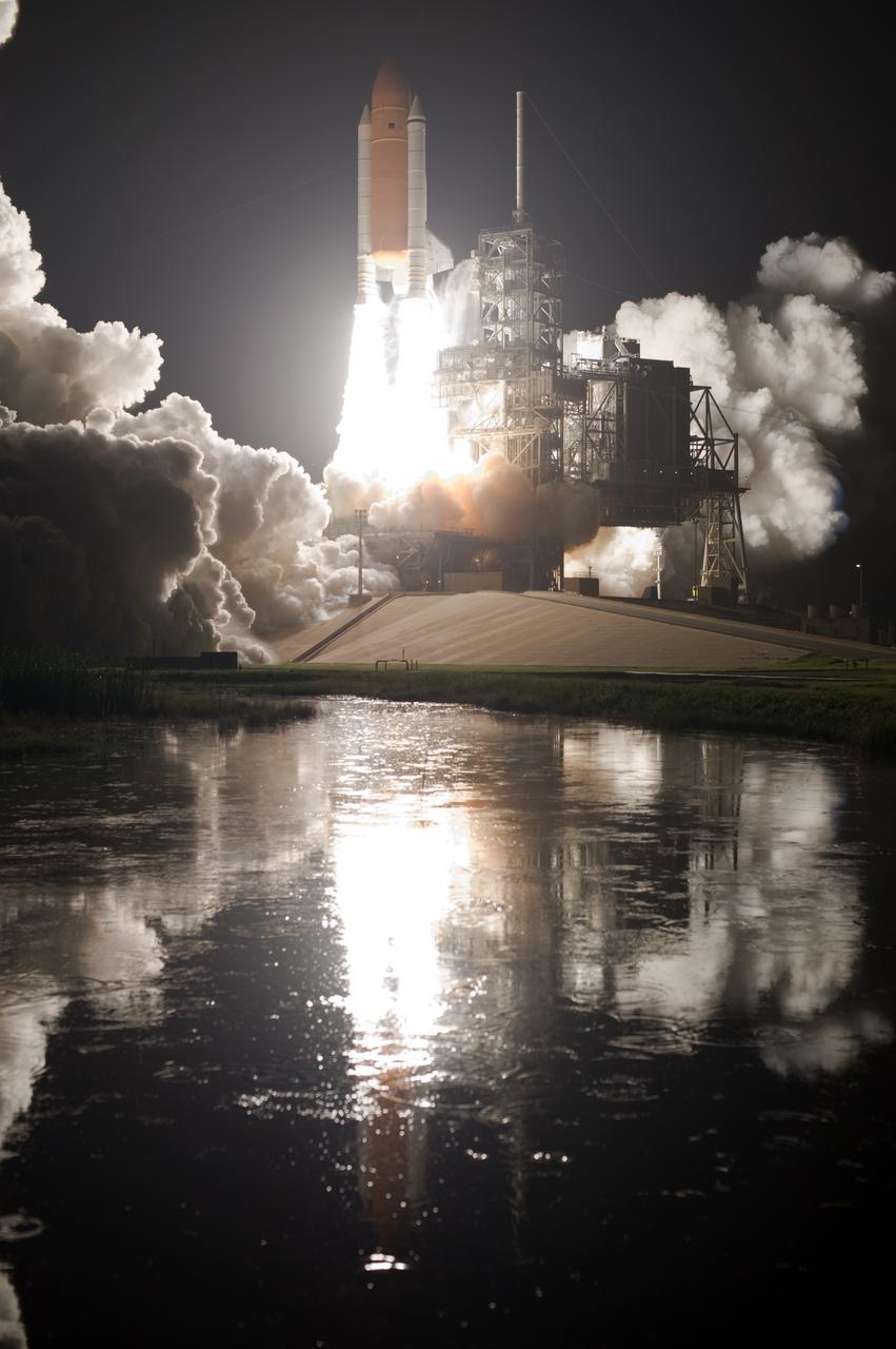 CAPE CANAVERAL, Fla. – The water close to Launch Pad 39A at NASA's Kennedy Space Center in Florida captures the firelight from space shuttle Discovery's launch on the STS-128 mission. Liftoff from Launch Pad 39A was on time at 11:59 p.m. EDT. The first launch attempt on Aug. 24 was postponed due to unfavorable weather conditions. The second attempt on Aug. 25 also was postponed due to an issue with a valve in space shuttle Discovery's main propulsion system. The STS-128 mission is the 30th International Space Station assembly flight and the 128th space shuttle flight. The 13-day mission will deliver more than 7 tons of supplies, science racks and equipment, as well as additional environmental hardware to sustain six crew members on the International Space Station. The equipment includes a freezer to store research samples, a new sleeping compartment and the COLBERT treadmill. Photo credit: NASA/Tony Gray-Tom Farrar
