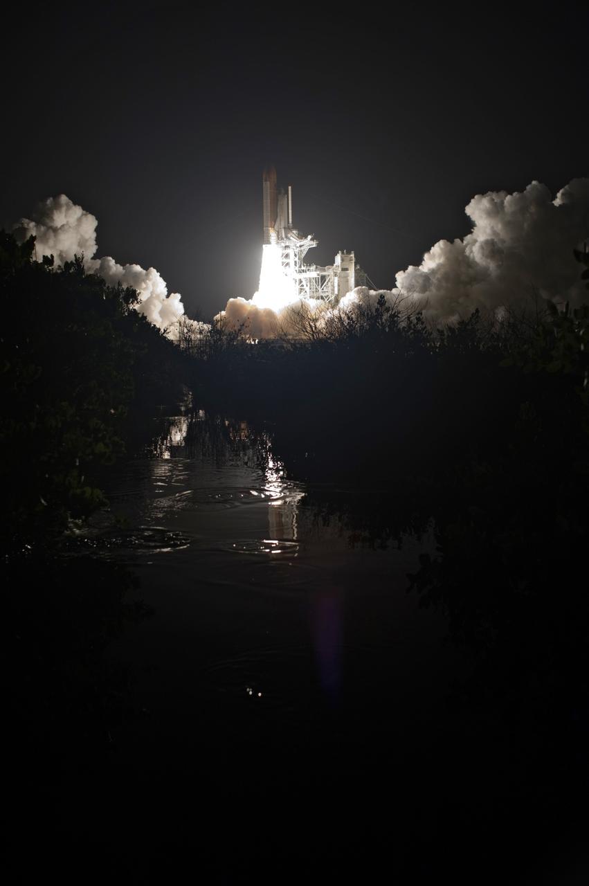 CAPE CANAVERAL, Fla. – Brilliant flames spread light across Launch Pad 39A at NASA's Kennedy Space Center in Florida as space shuttle Discovery roars toward space on the STS-128 mission. Liftoff from Launch Pad 39A was on time at 11:59 p.m. EDT. The first launch attempt on Aug. 24 was postponed due to unfavorable weather conditions. The second attempt on Aug. 25 also was postponed due to an issue with a valve in space shuttle Discovery's main propulsion system. The STS-128 mission is the 30th International Space Station assembly flight and the 128th space shuttle flight. The 13-day mission will deliver more than 7 tons of supplies, science racks and equipment, as well as additional environmental hardware to sustain six crew members on the International Space Station. The equipment includes a freezer to store research samples, a new sleeping compartment and the COLBERT treadmill. Photo credit: NASA/Tony Gray-Tom Farrar