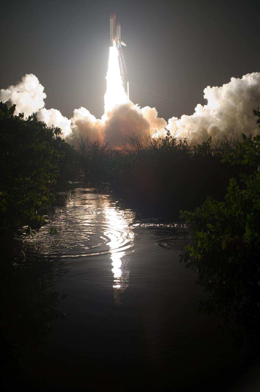 CAPE CANAVERAL, Fla. – The water close to Launch Pad 39A at NASA's Kennedy Space Center in Florida captures the brilliance from launch of space shuttle Discovery on the STS-128 mission. Liftoff from Launch Pad 39A was on time at 11:59 p.m. EDT. The first launch attempt on Aug. 24 was postponed due to unfavorable weather conditions. The second attempt on Aug. 25 also was postponed due to an issue with a valve in space shuttle Discovery's main propulsion system. The STS-128 mission is the 30th International Space Station assembly flight and the 128th space shuttle flight. The 13-day mission will deliver more than 7 tons of supplies, science racks and equipment, as well as additional environmental hardware to sustain six crew members on the International Space Station. The equipment includes a freezer to store research samples, a new sleeping compartment and the COLBERT treadmill. Photo credit: NASA/Tony Gray-Tom Farrar