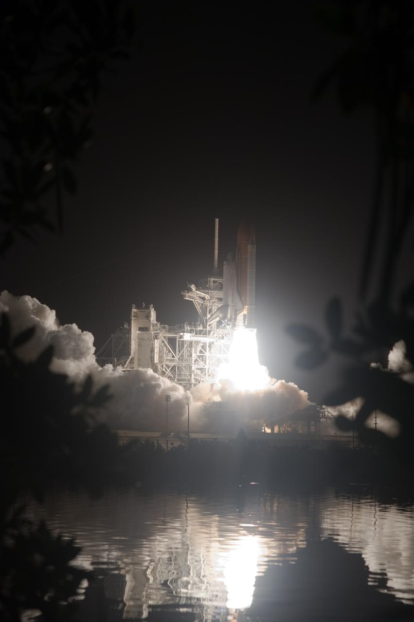 CAPE CANAVERAL, Fla. – The brilliance of space shuttle Discovery's liftoff at NASA's Kennedy Space Center in Florida is captured in the water near Launch Pad 39A. Liftoff on the STS-128 mission was on time at 11:59 p.m. EDT. The first launch attempt on Aug. 24 was postponed due to unfavorable weather conditions. The second attempt on Aug. 25 also was postponed due to an issue with a valve in space shuttle Discovery's main propulsion system. The STS-128 mission is the 30th International Space Station assembly flight and the 128th space shuttle flight. The 13-day mission will deliver more than 7 tons of supplies, science racks and equipment, as well as additional environmental hardware to sustain six crew members on the International Space Station. The equipment includes a freezer to store research samples, a new sleeping compartment and the COLBERT treadmill. Photo credit: NASA/Sandra Joseph-Kevin O'Connell