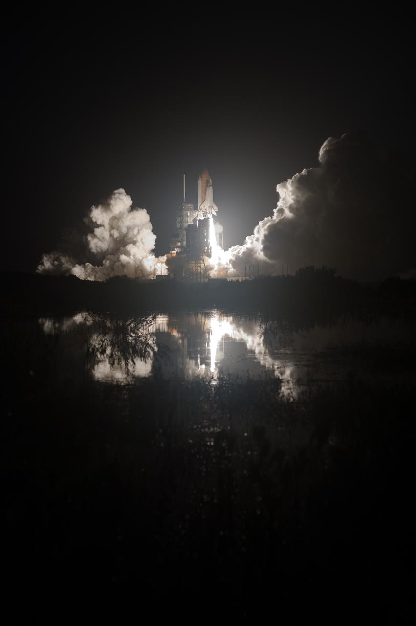 CAPE CANAVERAL, Fla. – Billows of smoke and steam rise alongside space shuttle Discovery as it lifts off Launch Pad 39A at NASA's Kennedy Space Center in Florida, racing toward space on the STS-128 mission. Liftoff was on time at 11:59 p.m. EDT. The first launch attempt on Aug. 24 was postponed due to unfavorable weather conditions. The second attempt on Aug. 25 also was postponed due to an issue with a valve in space shuttle Discovery's main propulsion system. The STS-128 mission is the 30th International Space Station assembly flight and the 128th space shuttle flight. The 13-day mission will deliver more than 7 tons of supplies, science racks and equipment, as well as additional environmental hardware to sustain six crew members on the International Space Station. The equipment includes a freezer to store research samples, a new sleeping compartment and the COLBERT treadmill. Photo credit: NASA/Tony Gray-Tom Farrar