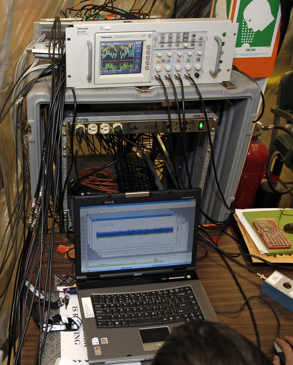 CAPE CANAVERAL, Fla. – In the Vehicle Assembly Building's High Bay 4 at NASA's Kennedy Space Center in Florida, equipment collects data from a sway test being conducted on the Ares I-X launch vehicle. The test is simulating conditions the rocket could experience during rollout to Launch Pad 39B, wind conditions at the pad and first-stage ignition. During the test, vibrations are mechanically induced into the rocket by four hydraulic shakers and a sway is manually introduced for lateral motion to measure the vehicle's response. A total of 44 accelerometers are installed on the flight test vehicle that required more than 27,000 feet of cable. Part of the Constellation Program, the Ares I-X is the test vehicle for the Ares I, which is the essential core of a space transportation system that eventually will carry crewed missions back to the moon, on to Mars and out into the solar system . The Ares I-X flight test is targeted for Oct. 31. Photo credit: NASA/Kim Shiflett