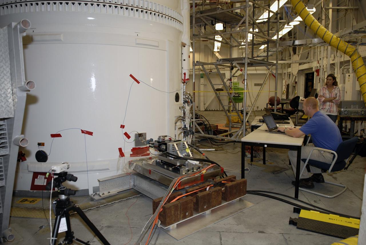CAPE CANAVERAL, Fla. – In the Vehicle Assembly Building's High Bay 4 at NASA's Kennedy Space Center in Florida, a worker seated at the table monitors data collected during a sway test on the Ares I-X launch vehicle. The test is simulating conditions the rocket could experience during rollout to Launch Pad 39B, wind conditions at the pad and first-stage ignition. During the test, vibrations are mechanically induced into the rocket by four hydraulic shakers and a sway is manually introduced for lateral motion to measure the vehicle's response. A total of 44 accelerometers are installed on the flight test vehicle that required more than 27,000 feet of cable. Part of the Constellation Program, the Ares I-X is the test vehicle for the Ares I, which is the essential core of a space transportation system that eventually will carry crewed missions back to the moon, on to Mars and out into the solar system . The Ares I-X flight test is targeted for Oct. 31. Photo credit: NASA/Kim Shiflett