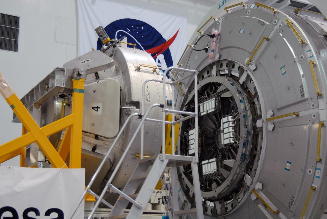 CAPE CANAVERAL, Fla. – In the Space Station Processing Facility at NASA's Kennedy Space Center in Florida,  NASA's Cupola module, at left, is being aligned with the Tranquility module, at right, for assembly.  Cupola and Tranquility are the payload for space shuttle Endeavour's STS-130 mission to the International Space Station.  The module was built for the European Space Agency by Alenia Spazio in Turin, Italy. When attached to the Tranquility Node 3 module, Cupola will resemble a circular bay window that will provide a vastly improved view of the station's exterior. Just under 10 feet in diameter, the module will accommodate two crew members and portable workstations that can control station and robotic activities. The multi-directional view will allow the crew to monitor spacewalks and docking operations, as well as provide a spectacular view of Earth and other celestial objects.  Endeavour is targeted to launch Feb. 4, 2010.  Photo credit: NASA/Jim Grossmann