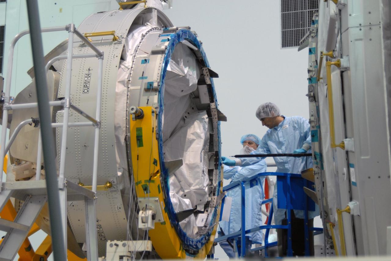 CAPE CANAVERAL, Fla. – In the Space Station Processing Facility at NASA's Kennedy Space Center in Florida,  workers check the Cupola module, at left, being aligned with the Tranquility module, at right, for assembly.  Cupola and Tranquility are the payload for space shuttle Endeavour's STS-130 mission to the International Space Station.  The module was built for the European Space Agency by Alenia Spazio in Turin, Italy. When attached to the Tranquility Node 3 module, Cupola will resemble a circular bay window that will provide a vastly improved view of the station's exterior. Just under 10 feet in diameter, the module will accommodate two crew members and portable workstations that can control station and robotic activities. The multi-directional view will allow the crew to monitor spacewalks and docking operations, as well as provide a spectacular view of Earth and other celestial objects.  Endeavour is targeted to launch Feb. 4, 2010.  Photo credit: NASA/Jim Grossmann