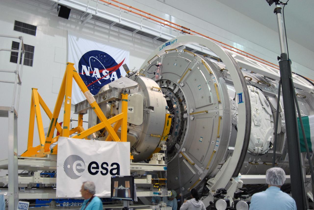 CAPE CANAVERAL, Fla. – On the stand in the Space Station Processing Facility at NASA's Kennedy Space Center in Florida,  NASA's Cupola module, at left, is being aligned with the Tranquility module, at right, for assembly.  Cupola and Tranquility are the payload for space shuttle Endeavour's STS-130 mission to the International Space Station. The module was built for the European Space Agency by Alenia Spazio in Turin, Italy. When attached to the Tranquility Node 3 module, Cupola will resemble a circular bay window that will provide a vastly improved view of the station's exterior. Just under 10 feet in diameter, the module will accommodate two crew members and portable workstations that can control station and robotic activities. The multi-directional view will allow the crew to monitor spacewalks and docking operations, as well as provide a spectacular view of Earth and other celestial objects.  Endeavour is targeted to launch Feb. 4, 2010.  Photo credit: NASA/Jim Grossmann