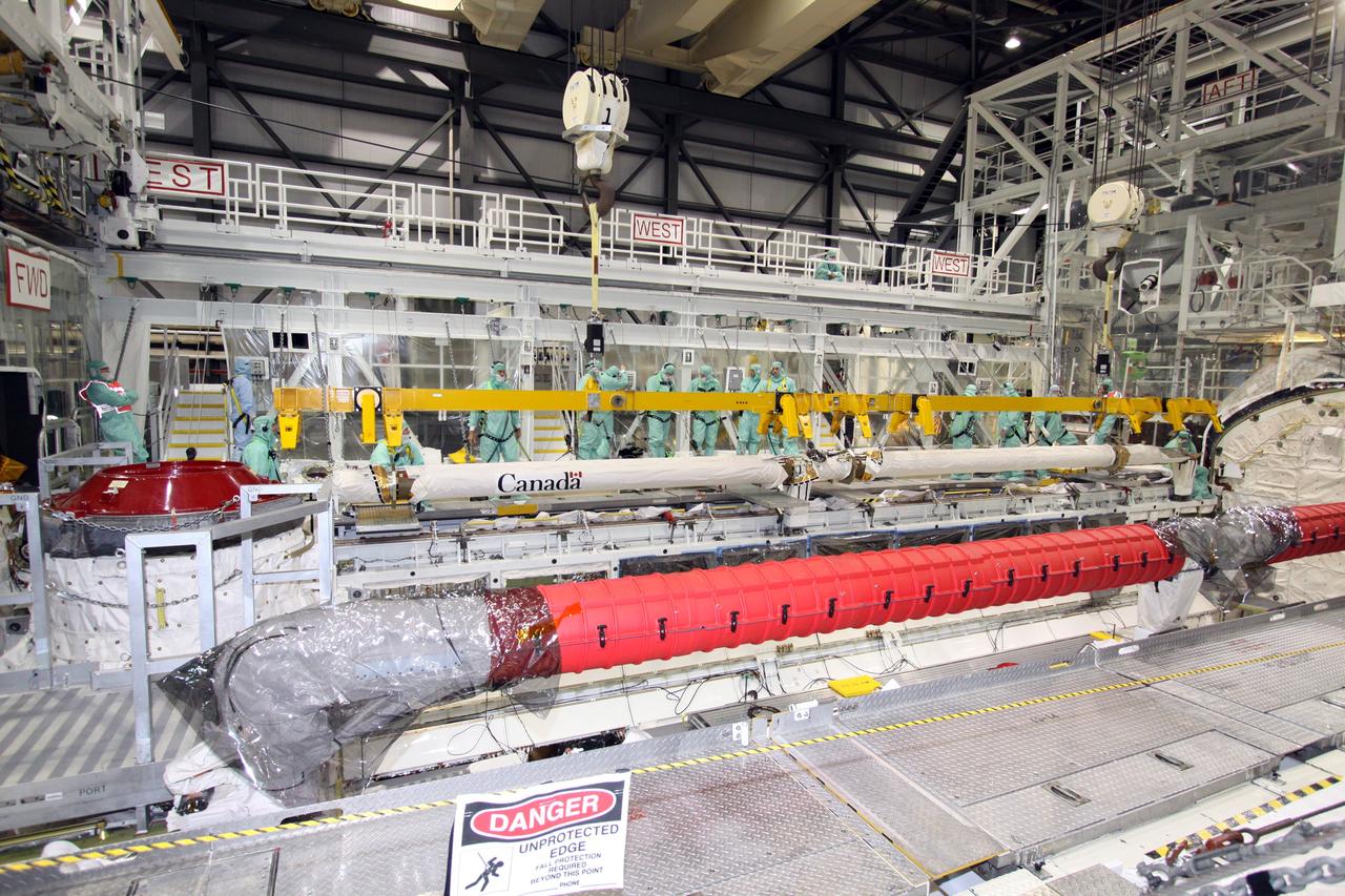CAPE CANAVERAL, Fla. – The Orbiter Boom Sensor System is being removed from space shuttle Endeavour in NASA Kennedy Space Center's Orbiter Processing Facility bay 2. After returning from the STS-127 mission July 31, 2009, Endeavour now is being processed for the STS-130 mission targeted for Feb. 4, 2010. Endeavour will deliver to the International Space Station the Tranquility pressurized module that will provide room for many of the station's life support systems. Photo credit: NASA/Jack Pfaller