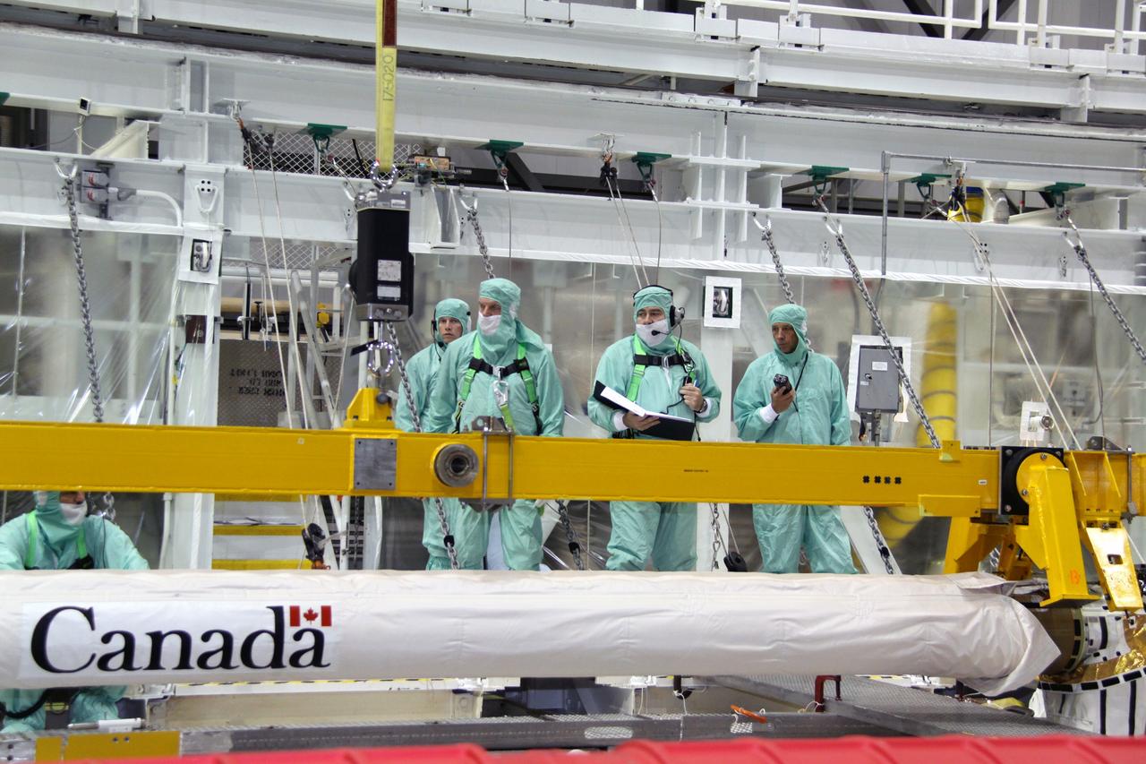 CAPE CANAVERAL, Fla. –In NASA Kennedy Space Center's Orbiter Processing Facility bay 2, a crane is being attached to space shuttle Endeavour's Orbiter Boom Sensor System for removal. After returning from the STS-127 mission July 31, 2009, Endeavour now is being processed for the STS-130 mission targeted for Feb. 4, 2010. Endeavour will deliver to the International Space Station the Tranquility pressurized module that will provide room for many of the station's life support systems. Photo credit: NASA/Jack Pfaller