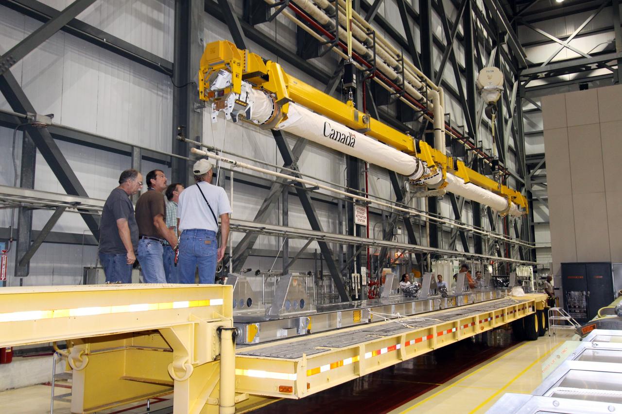 CAPE CANAVERAL, Fla. –In NASA Kennedy Space Center's Orbiter Processing Facility bay 2, a crane lowers space shuttle Endeavour's Orbiter Boom Sensor System toward a mobile stand. The OBSS was removed from Endeavour's payload bay. After returning from the STS-127 mission July 31, 2009, Endeavour now is being processed for the STS-130 mission targeted for Feb. 4, 2010. Endeavour will deliver to the International Space Station the Tranquility pressurized module that will provide room for many of the station's life support systems. Photo credit: NASA/Jack Pfaller